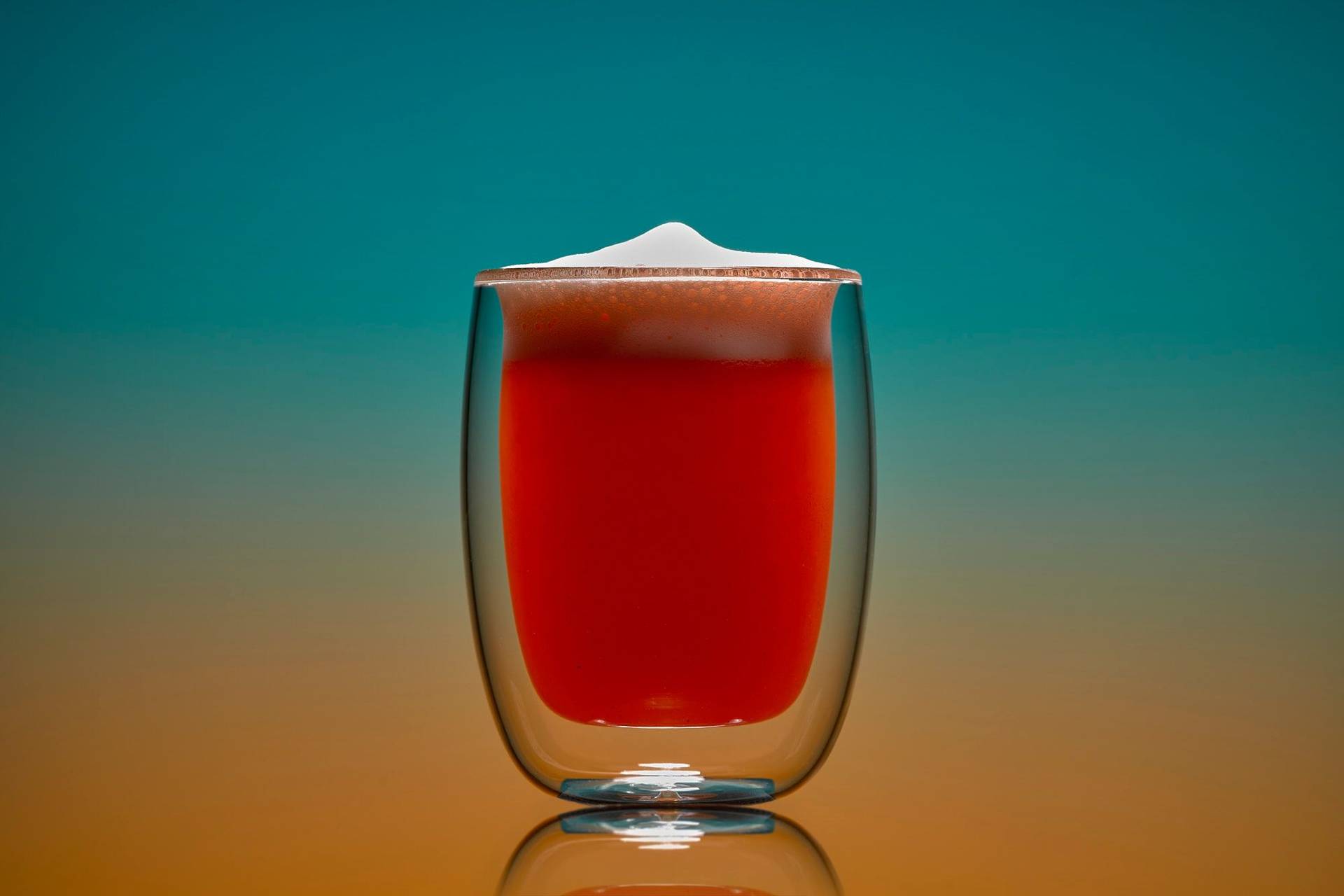 non-alcoholic grapefruit fizz mocktail on blue and orange background