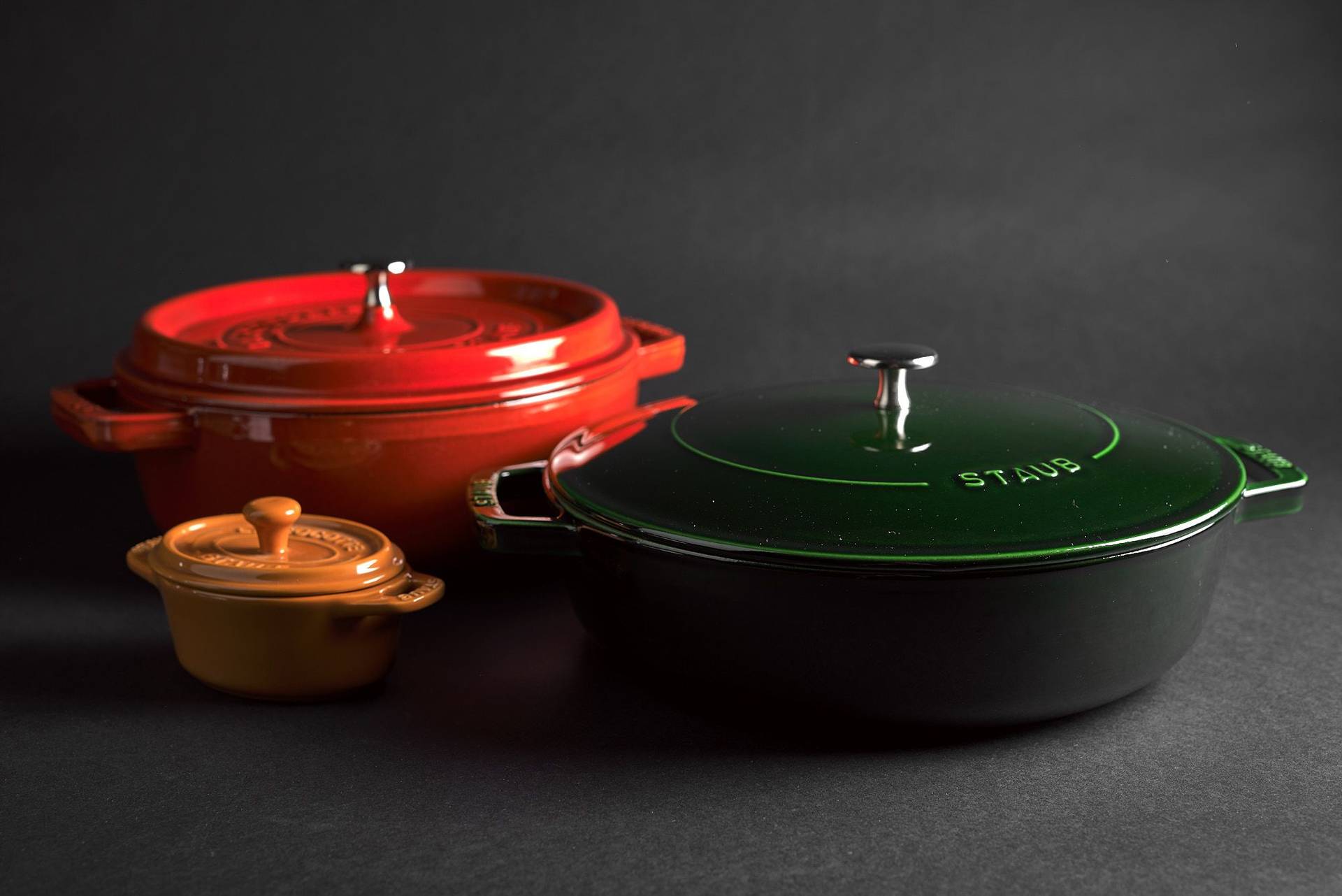 staub la cocotte cast iron pots on black background