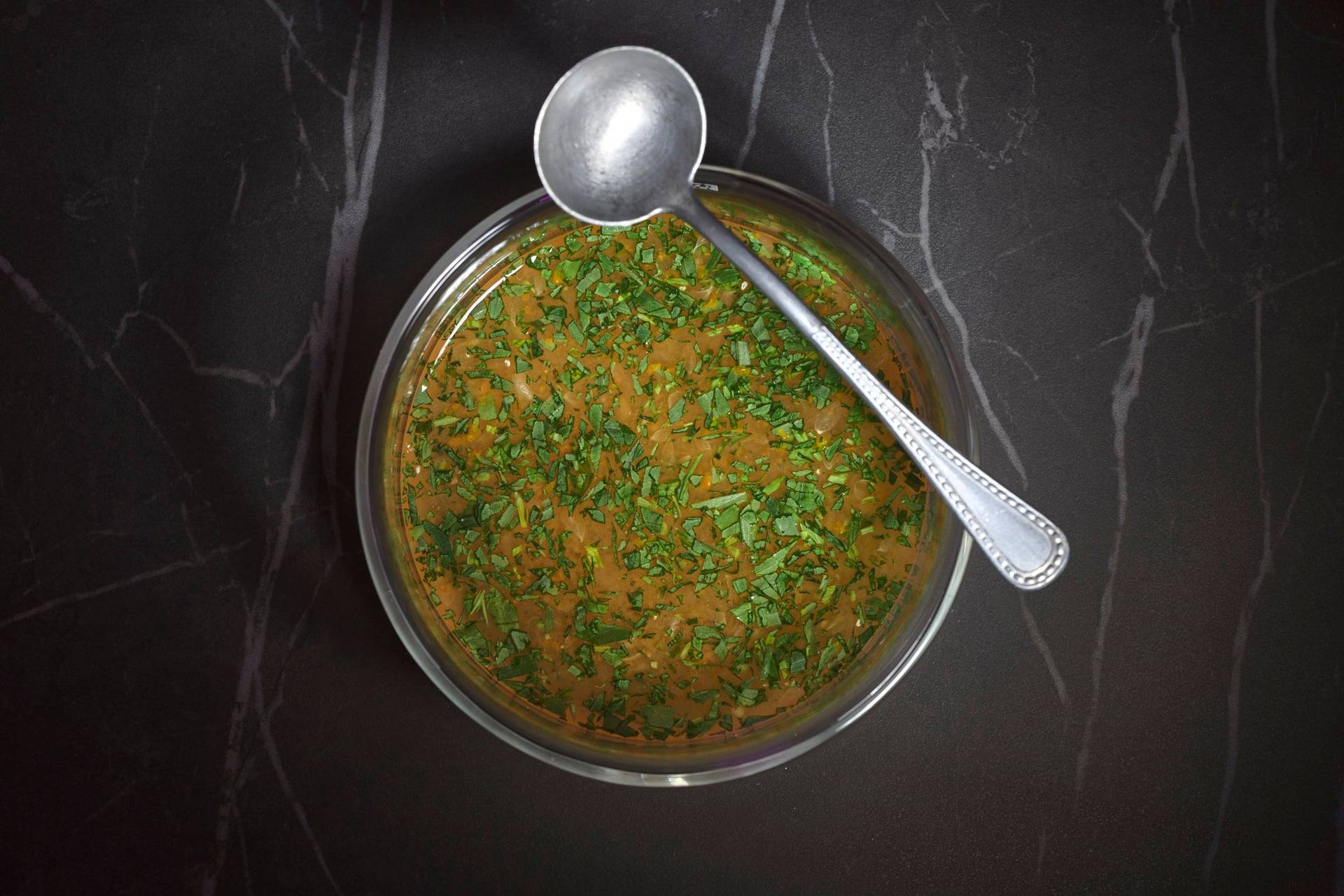 vietnamese summer rolls sauce in a glass bowl on a gray marbled sapienstone top 