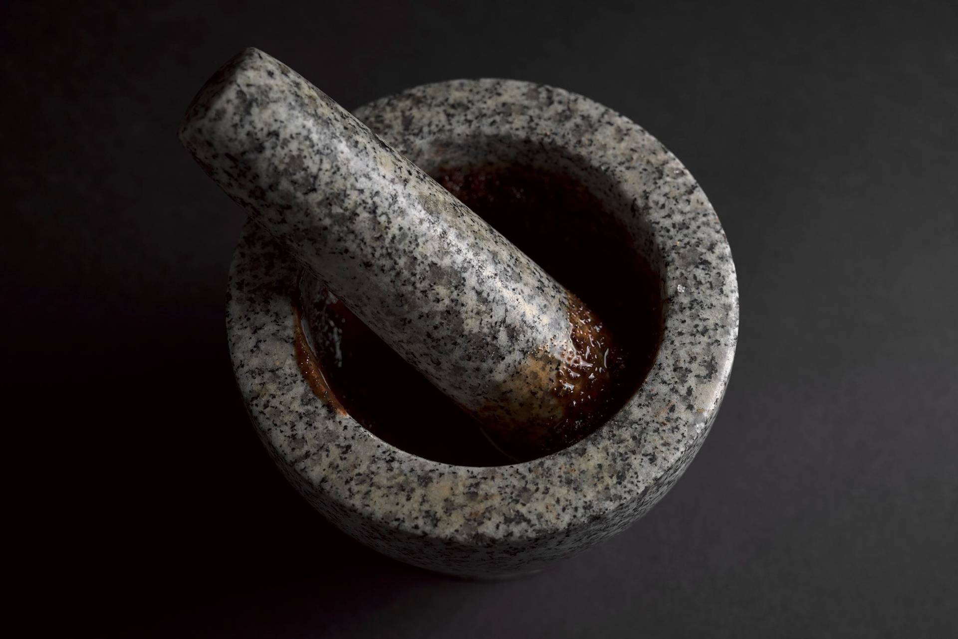 chocolate-pesto spicy chocolate pesto in a mortar with black background