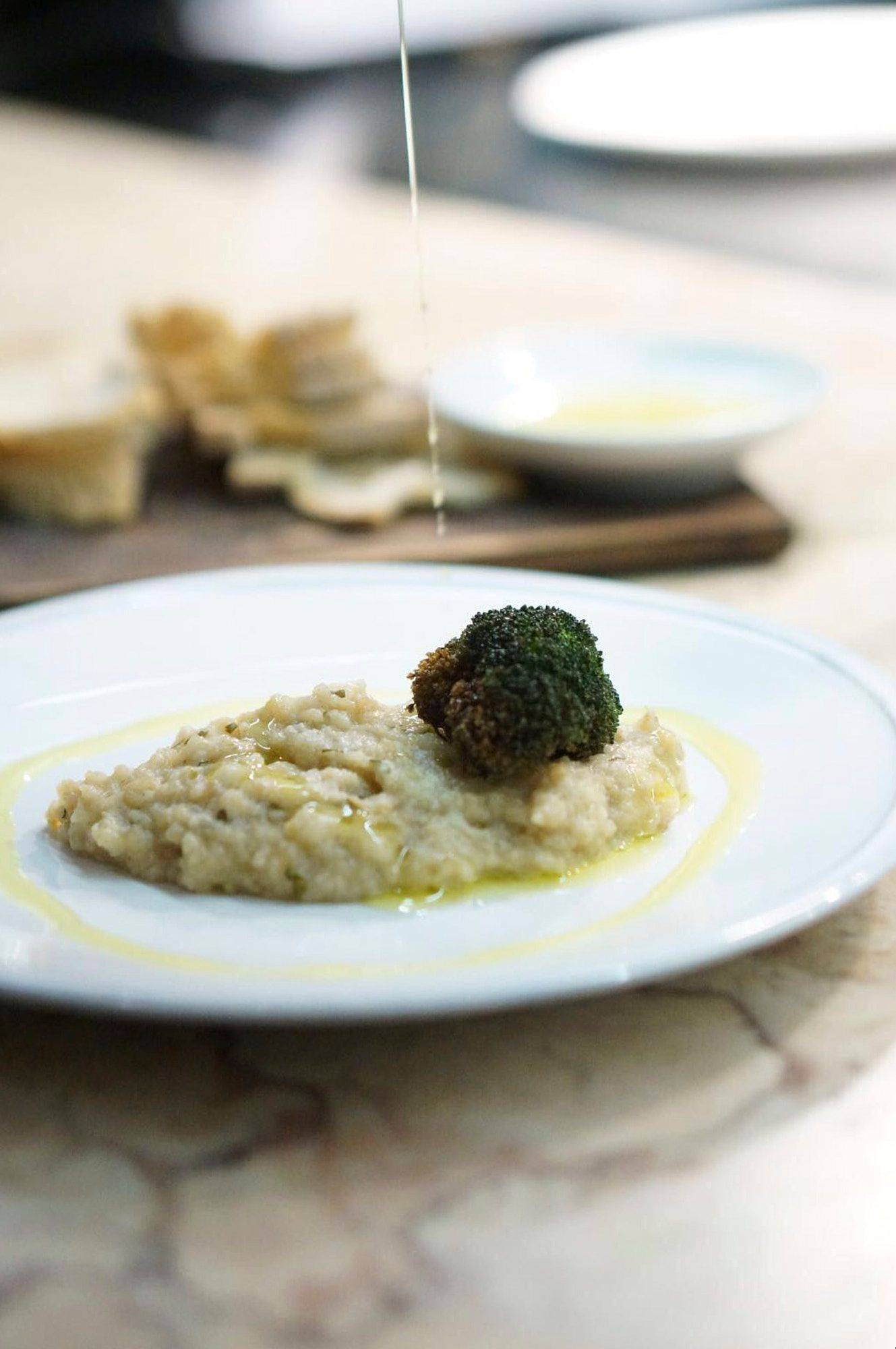 chef leopoldo calhau serving an olive oil dinner in lisbon