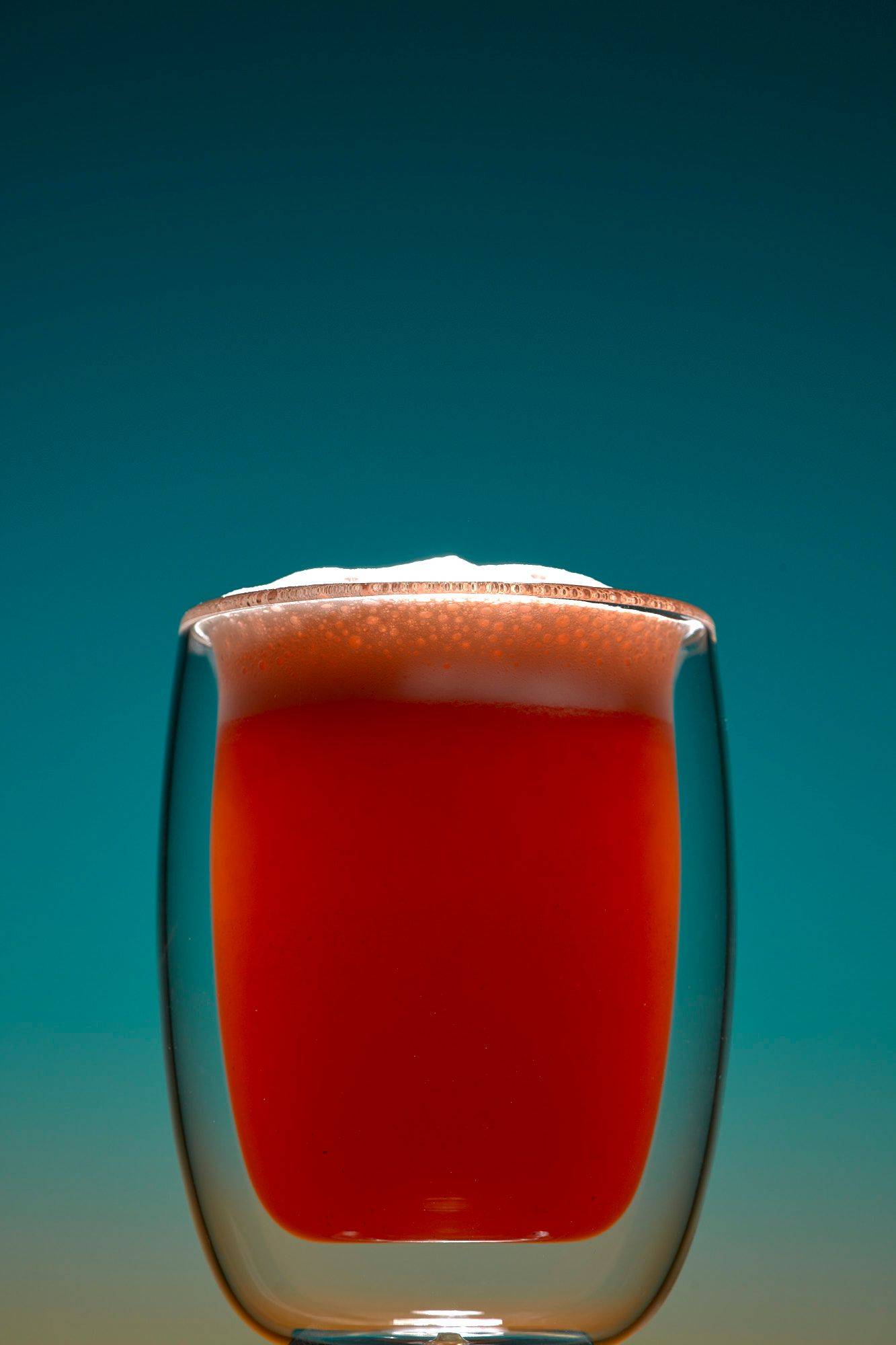 non-alcoholic grapefruit fizz mocktail on blue background