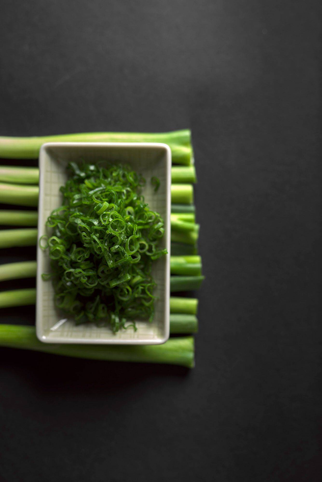 scallions on black background