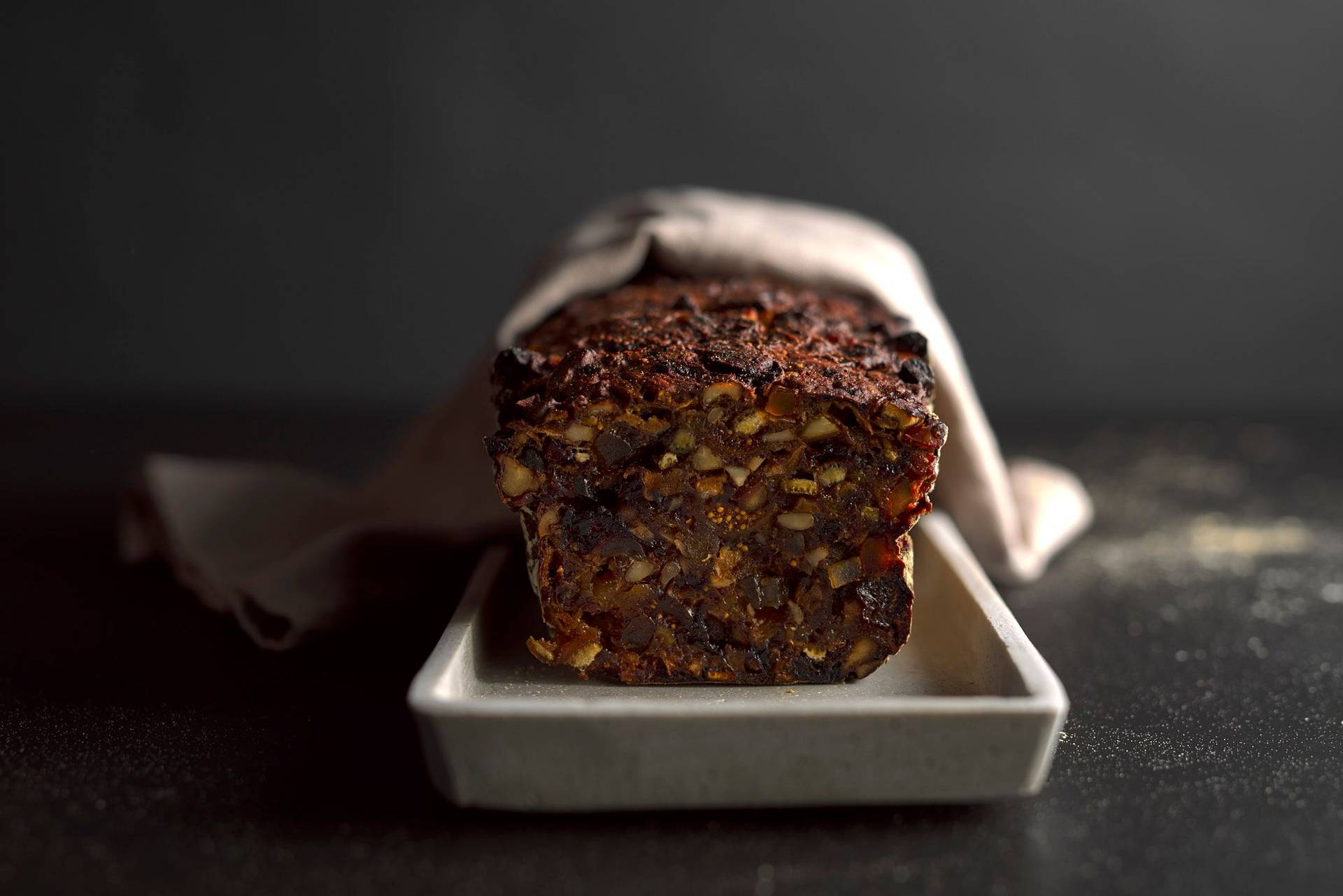 sugar-free fruit cake on a concrete plate with black background