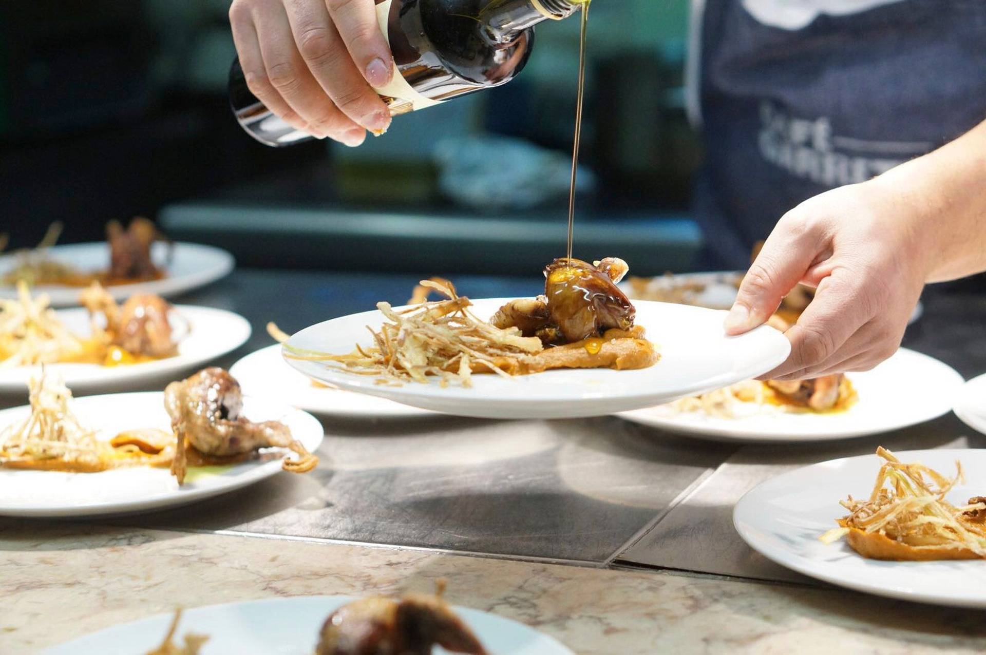 chef leopoldo calhau serving an olive oil dinner in lisbon