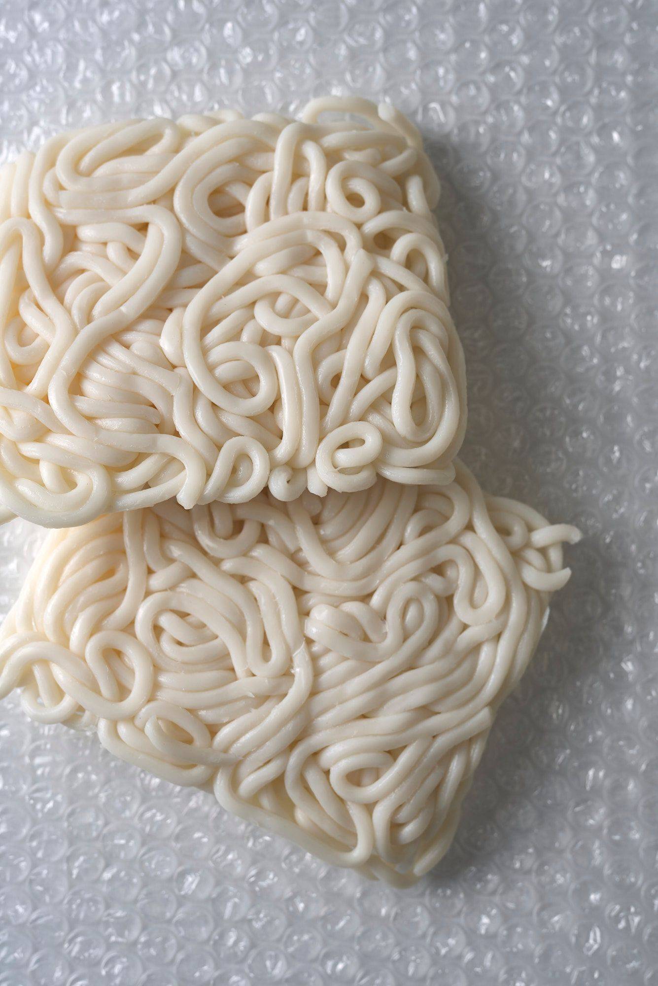 raw udon noodles on plastic foil