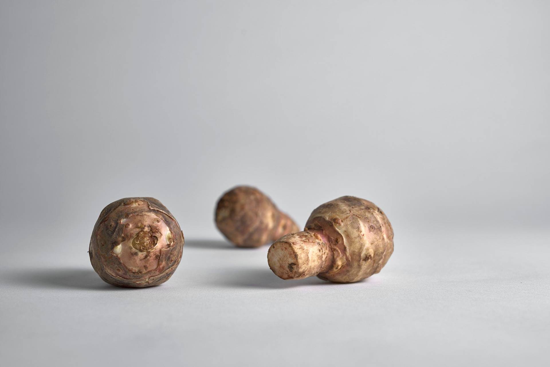 three jerusalem artichokes with white background