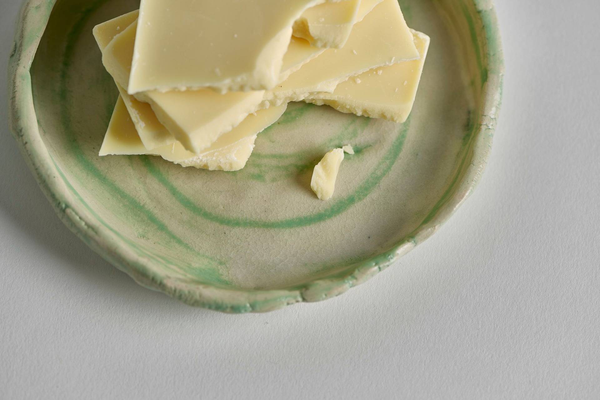 white chocolate on a ceramic plate with white background