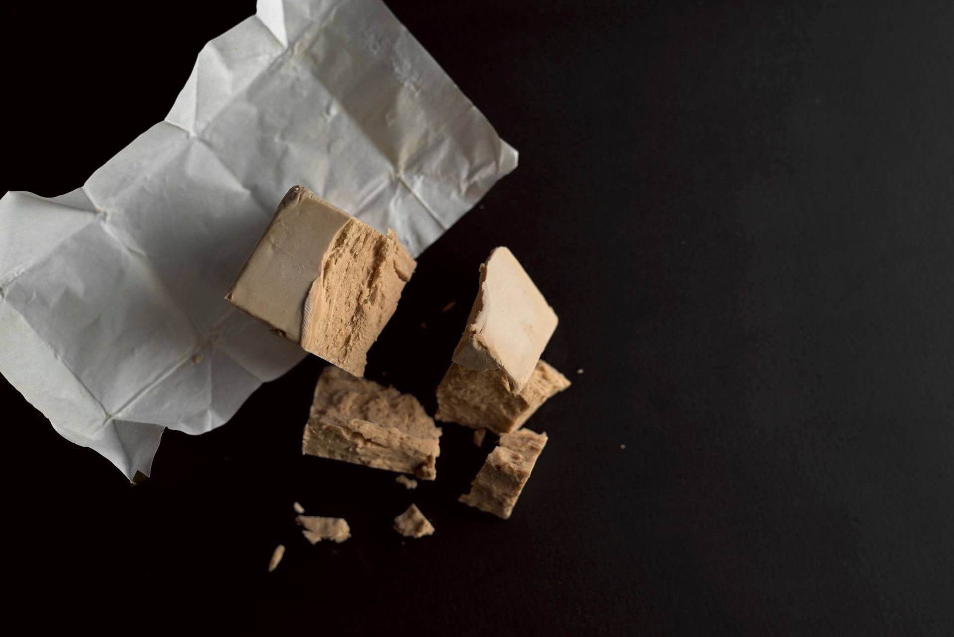 crumbled yeast with black background