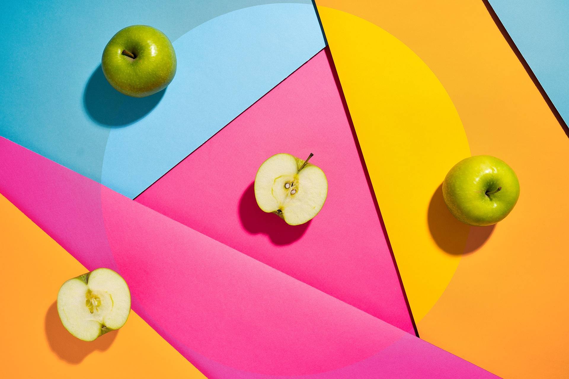 three green apples on colorful underground