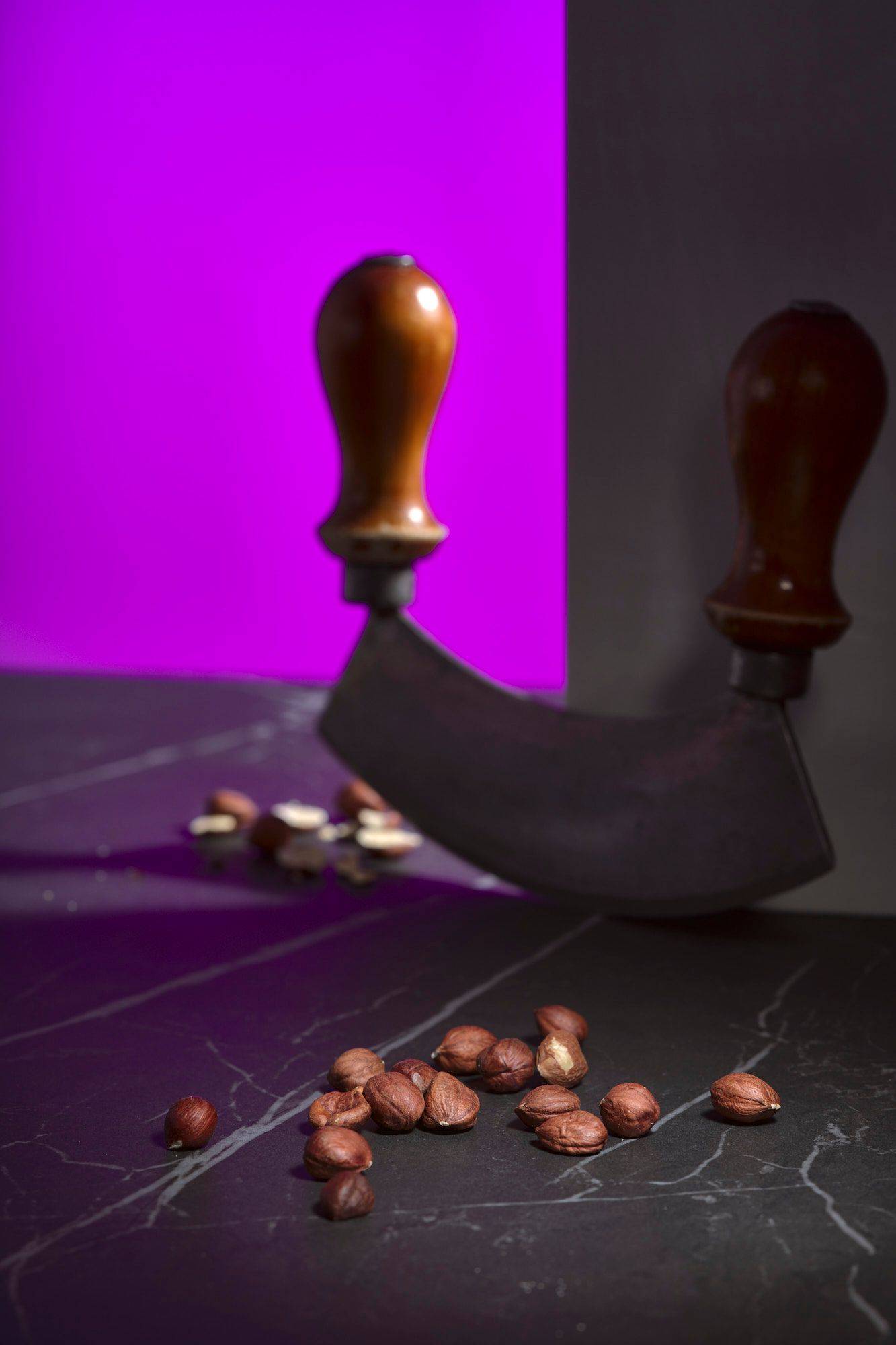 hazelnuts on a gray marbled sapienstone top with purple background