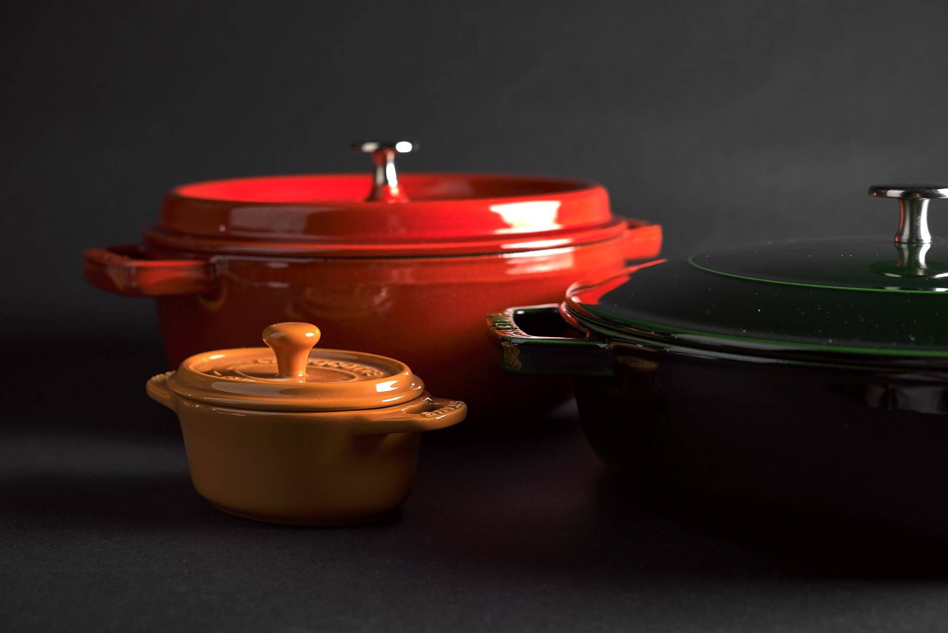 staub la cocotte cast iron pots on black background