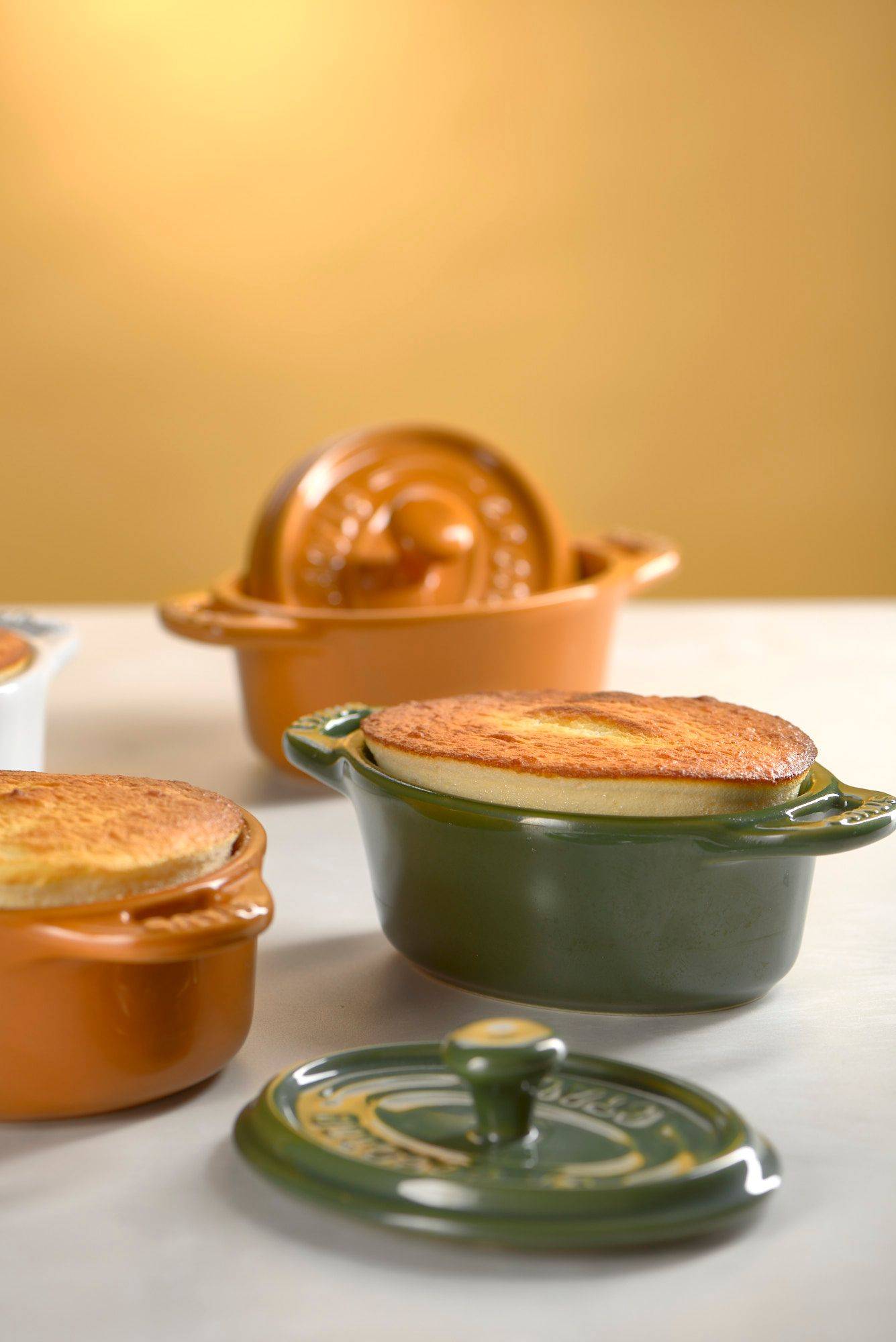 skyr souffle with lavender nectarines in small staub cocottes on white sapienstone top with yellow background