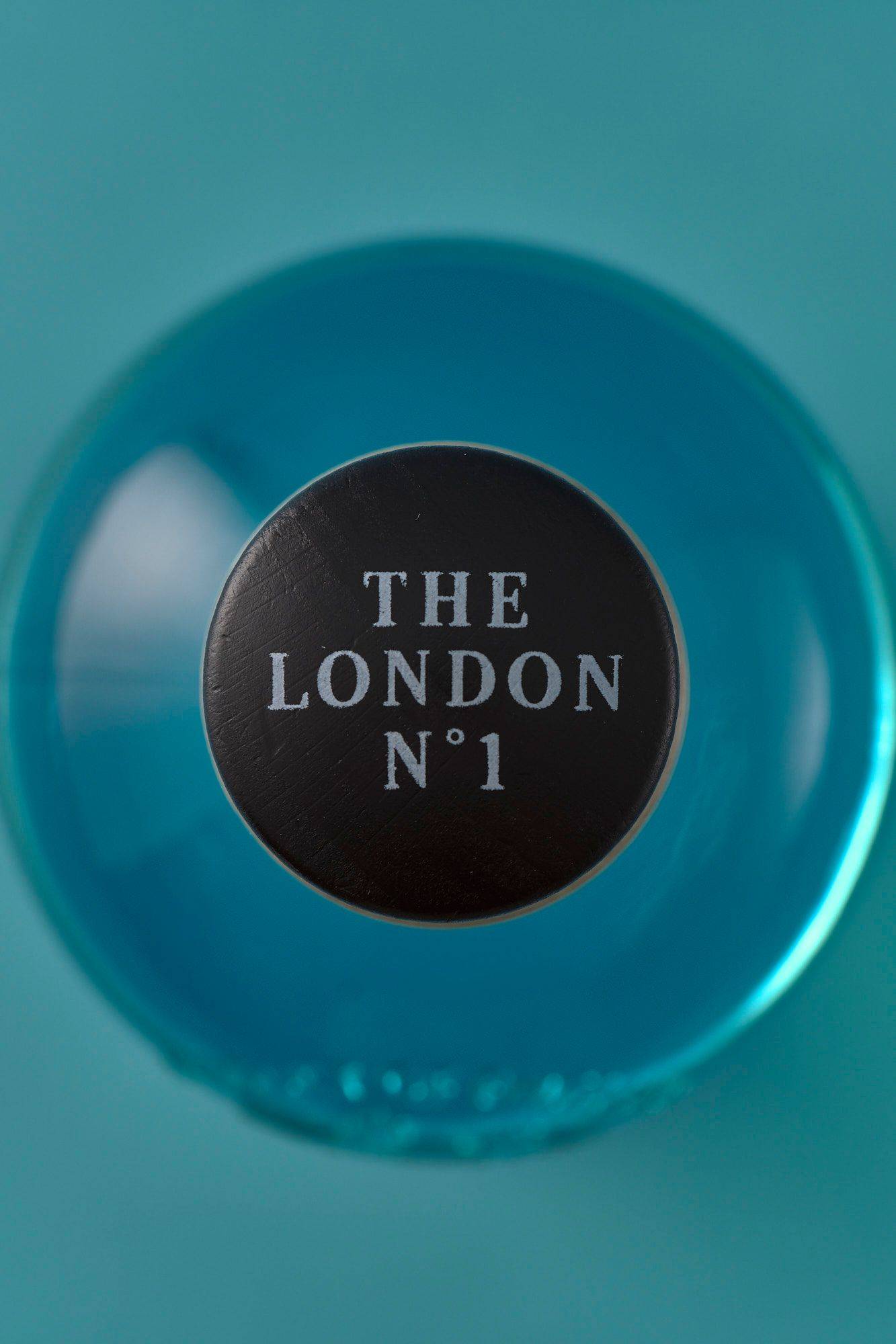 a bottle of the london number one gin on blue background