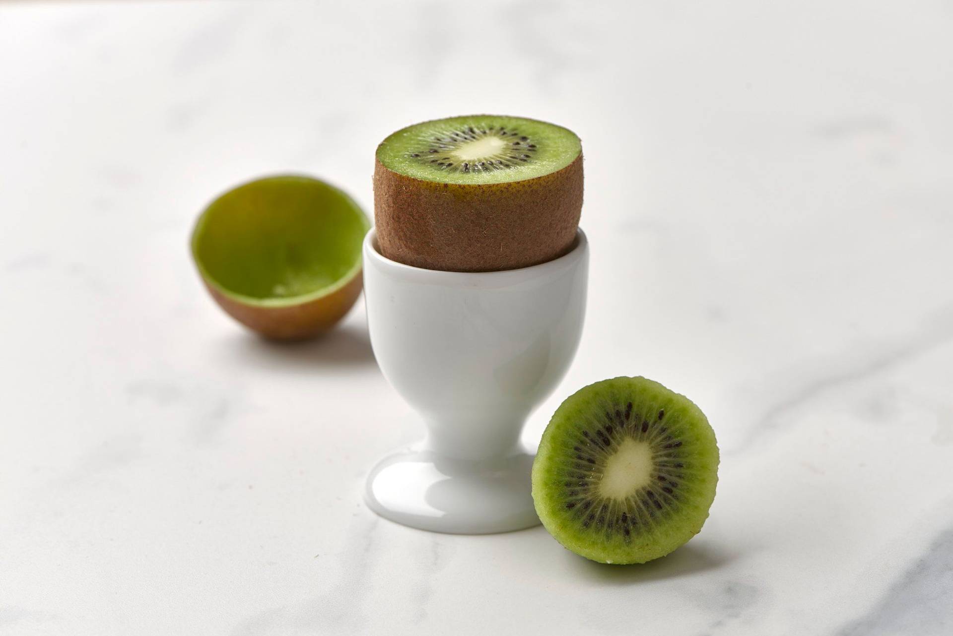 a zespri kiwi in an egg cup with a marbled sapienstone top