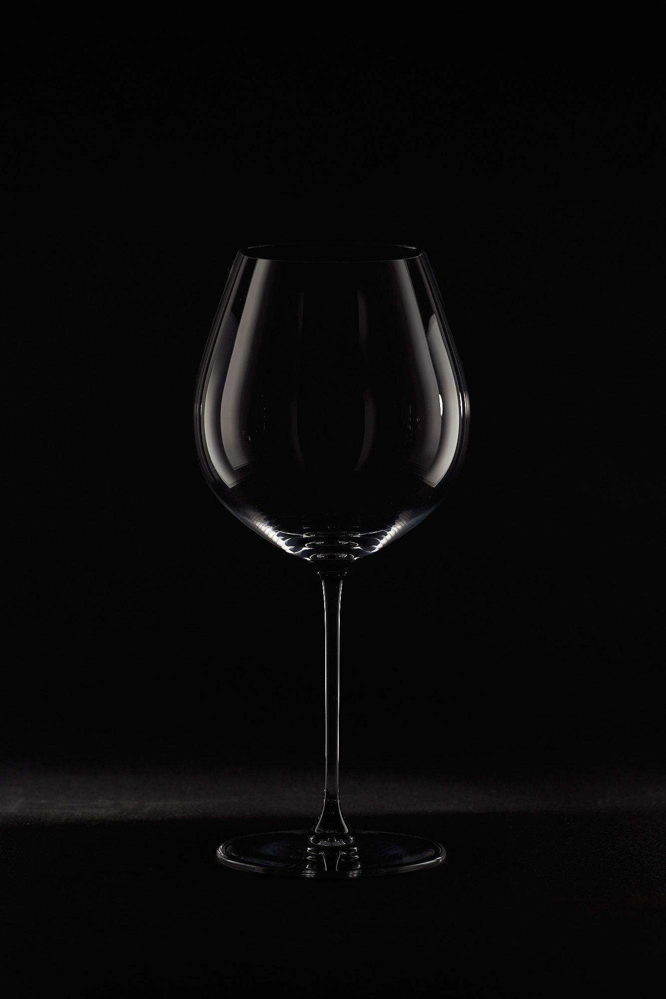 riedel veritas old world pinot noir wine glass on black background