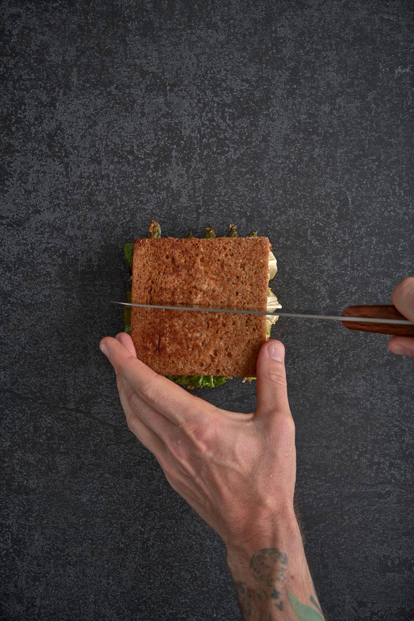 assembling-a-vegetarian-asparagus-katsu-sando-with-nectarine-and-mint-mayonnaise assembling a vegetarian asparagus katsu sando with nectarine and mint mayonnaise on a gray sapienstone top