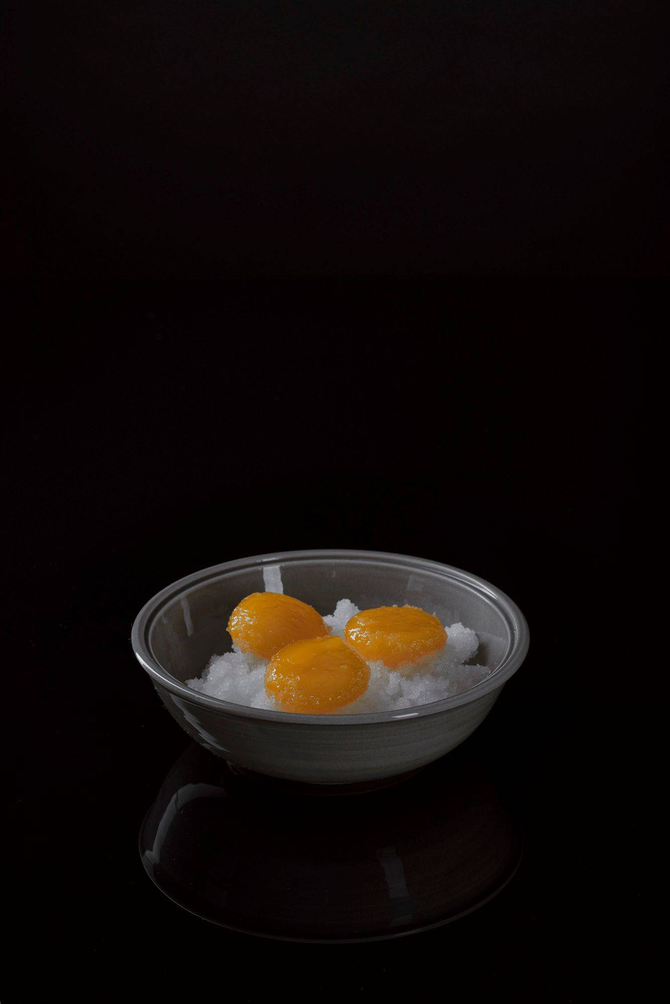 cured egg yolks with black background