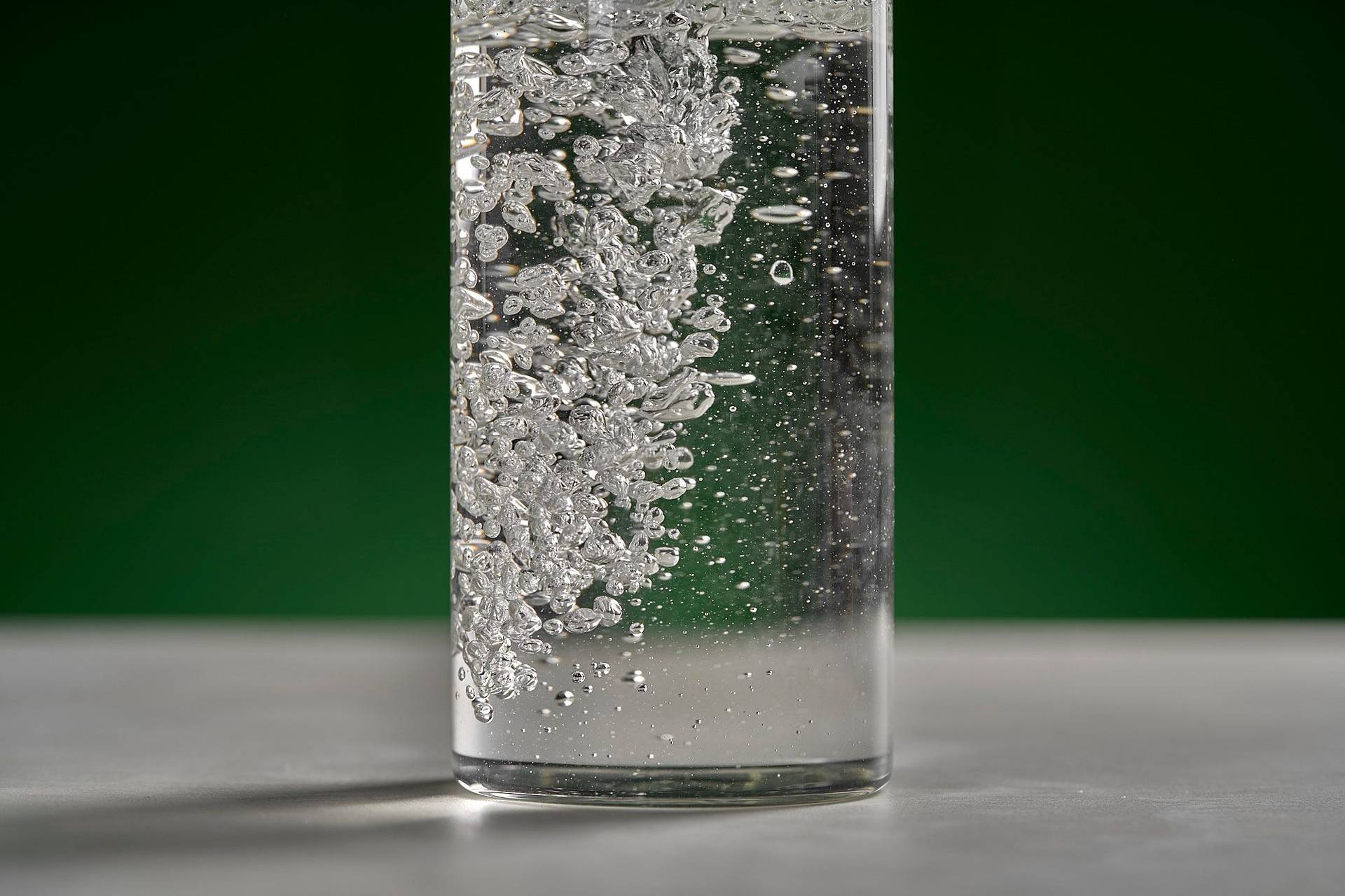 water on white sapienstone top with green background