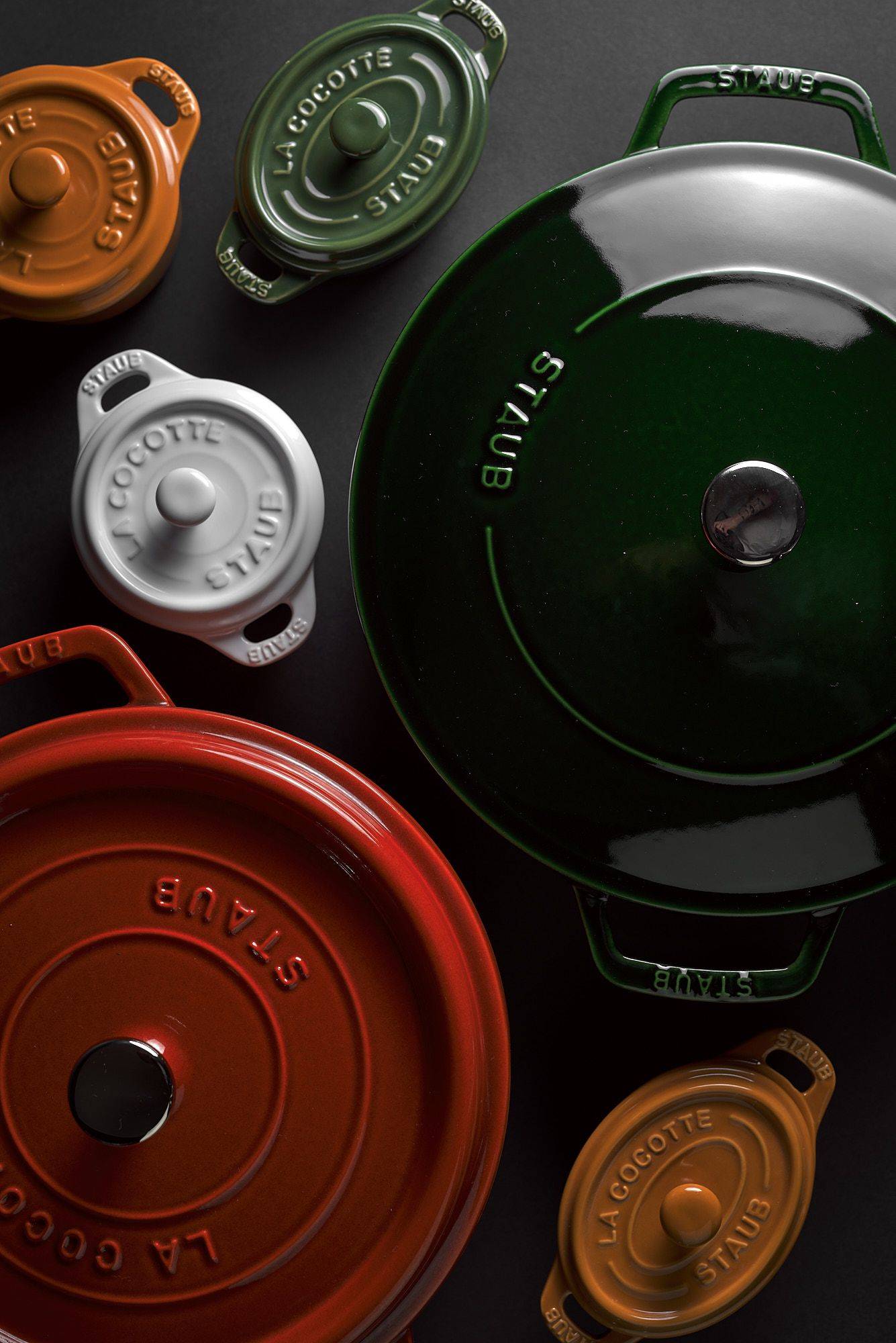 staub la cocotte cast iron pots on black background