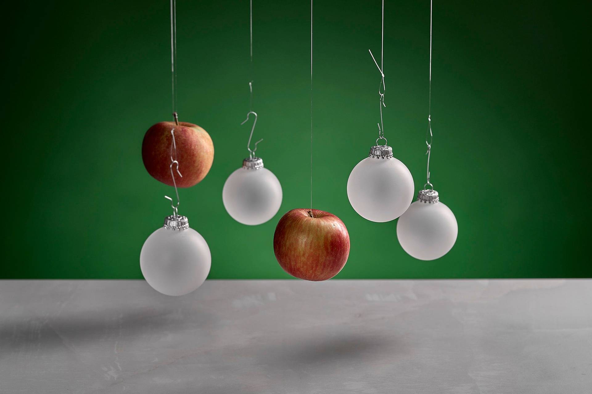 red-apples on white sapienstone top with green background
