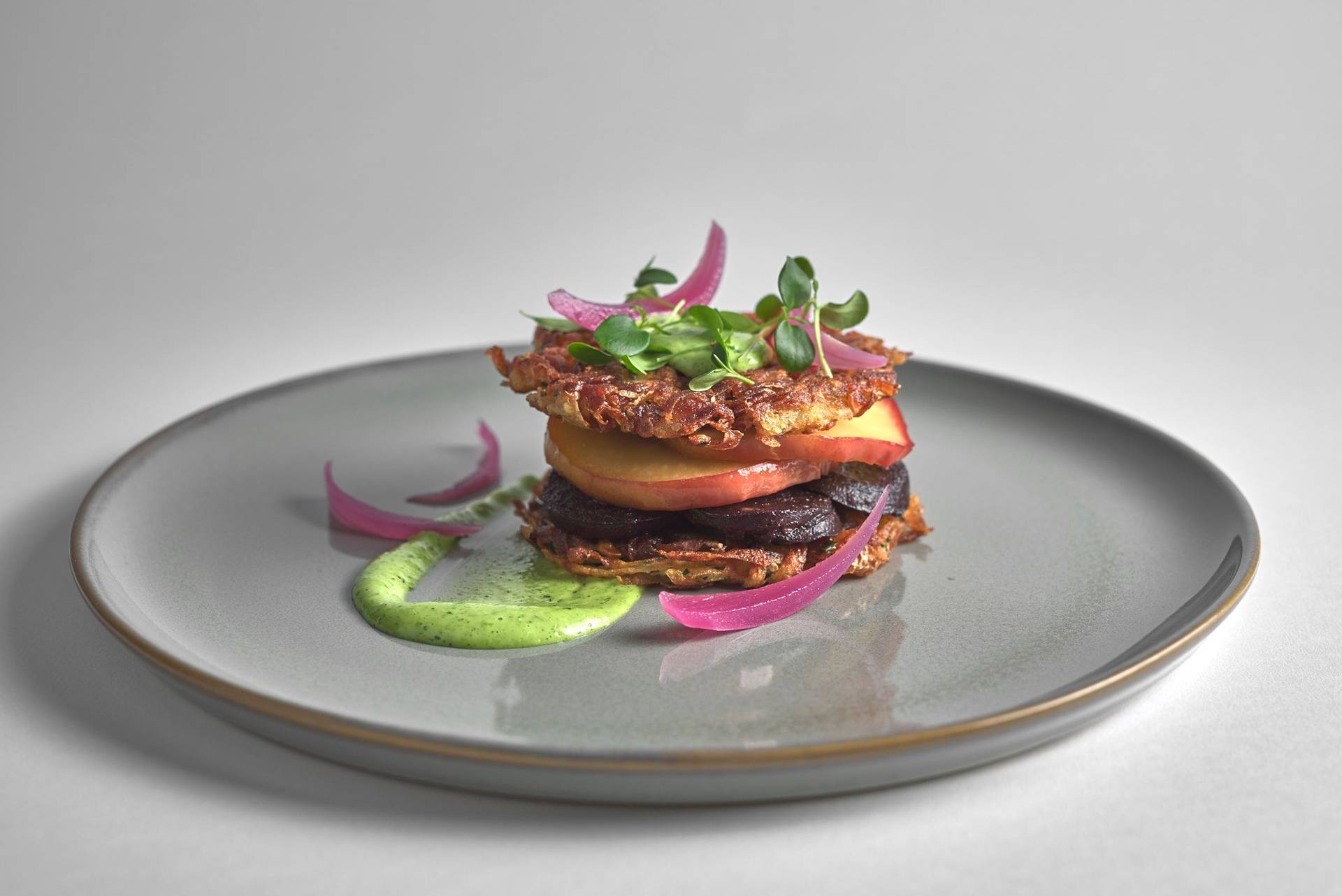 heaven and earth burger on a gray plate with white background