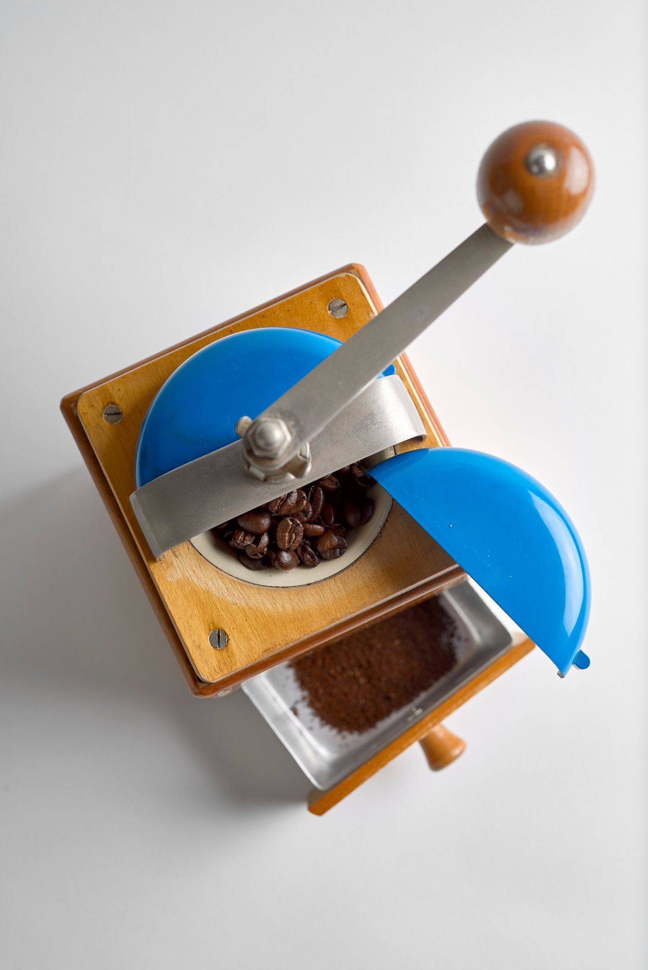 coffee coffee in a vintage hand mill on white background