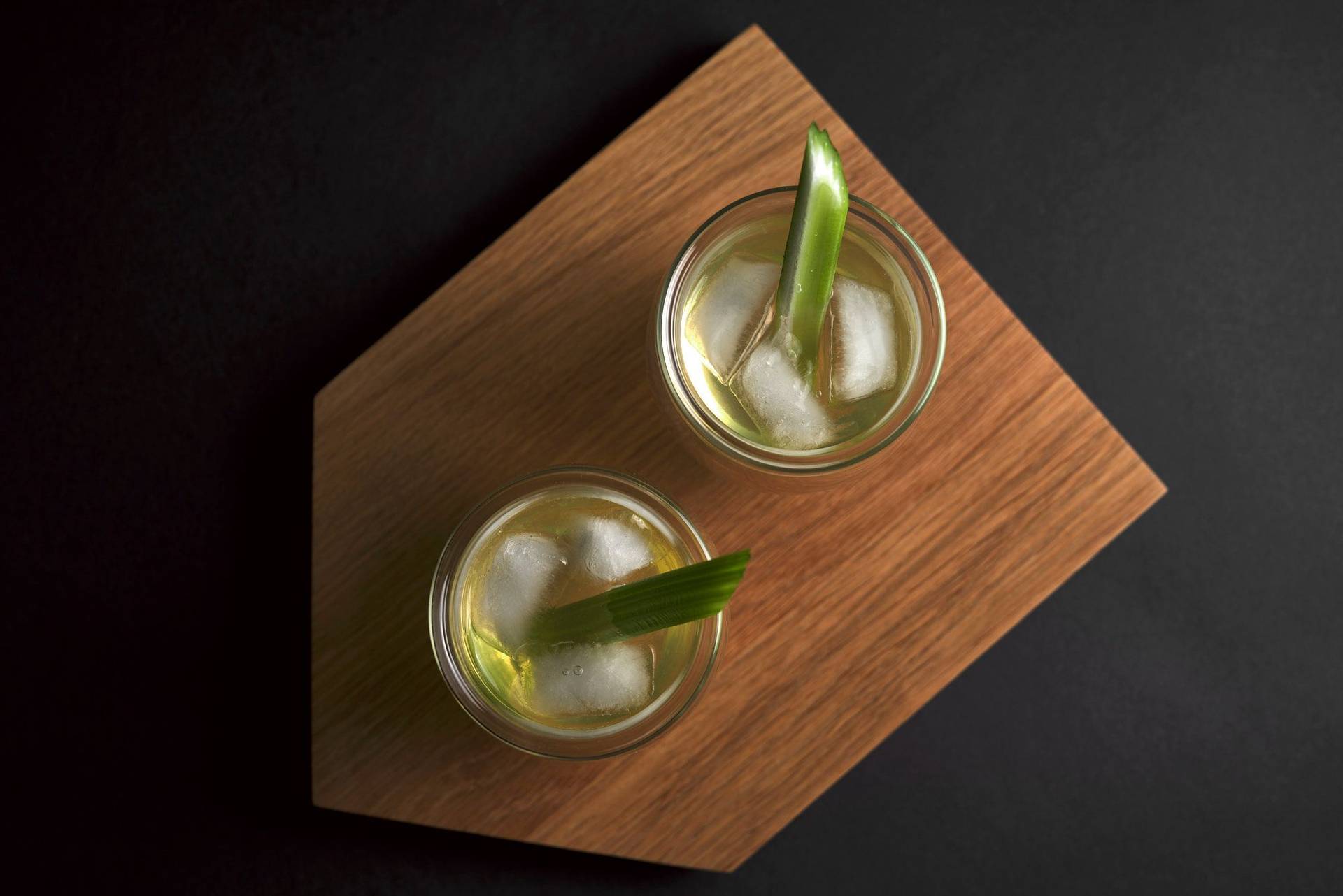 white-bloody-mary-cocktail two glasses of white bloody mary on a wooden tray with black background