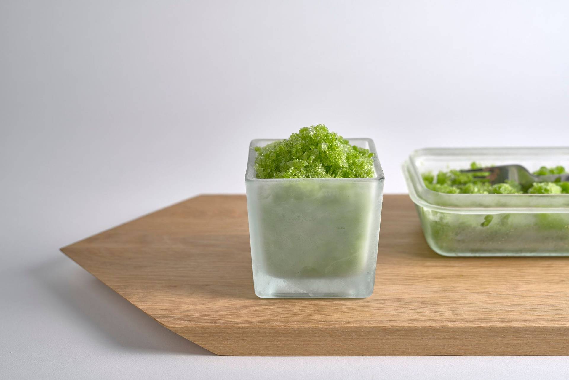 frozen dill granita on a wooden board with white background