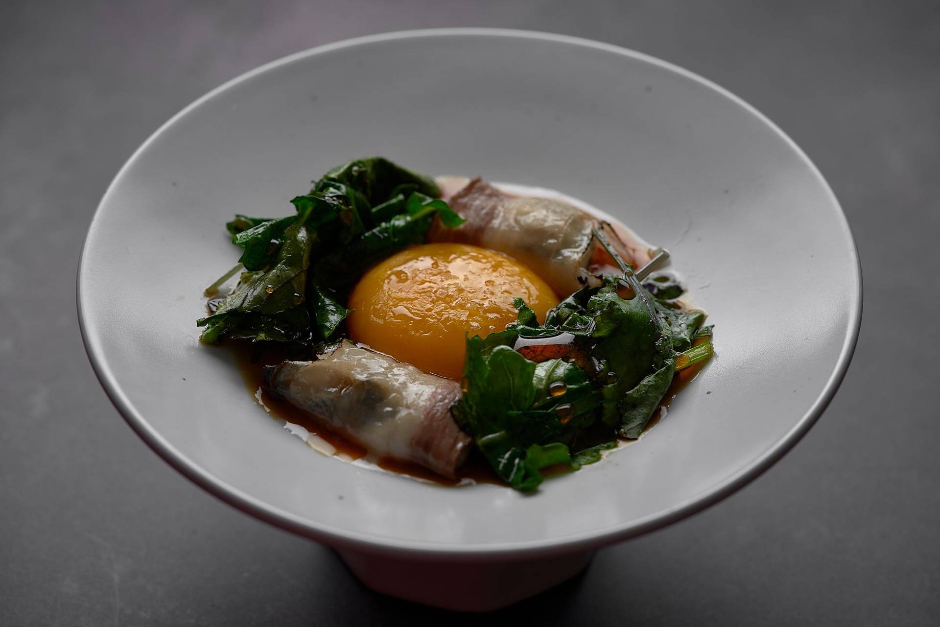 poached oyster lardo bacon egg yolk kale and ponzu at le duc salon