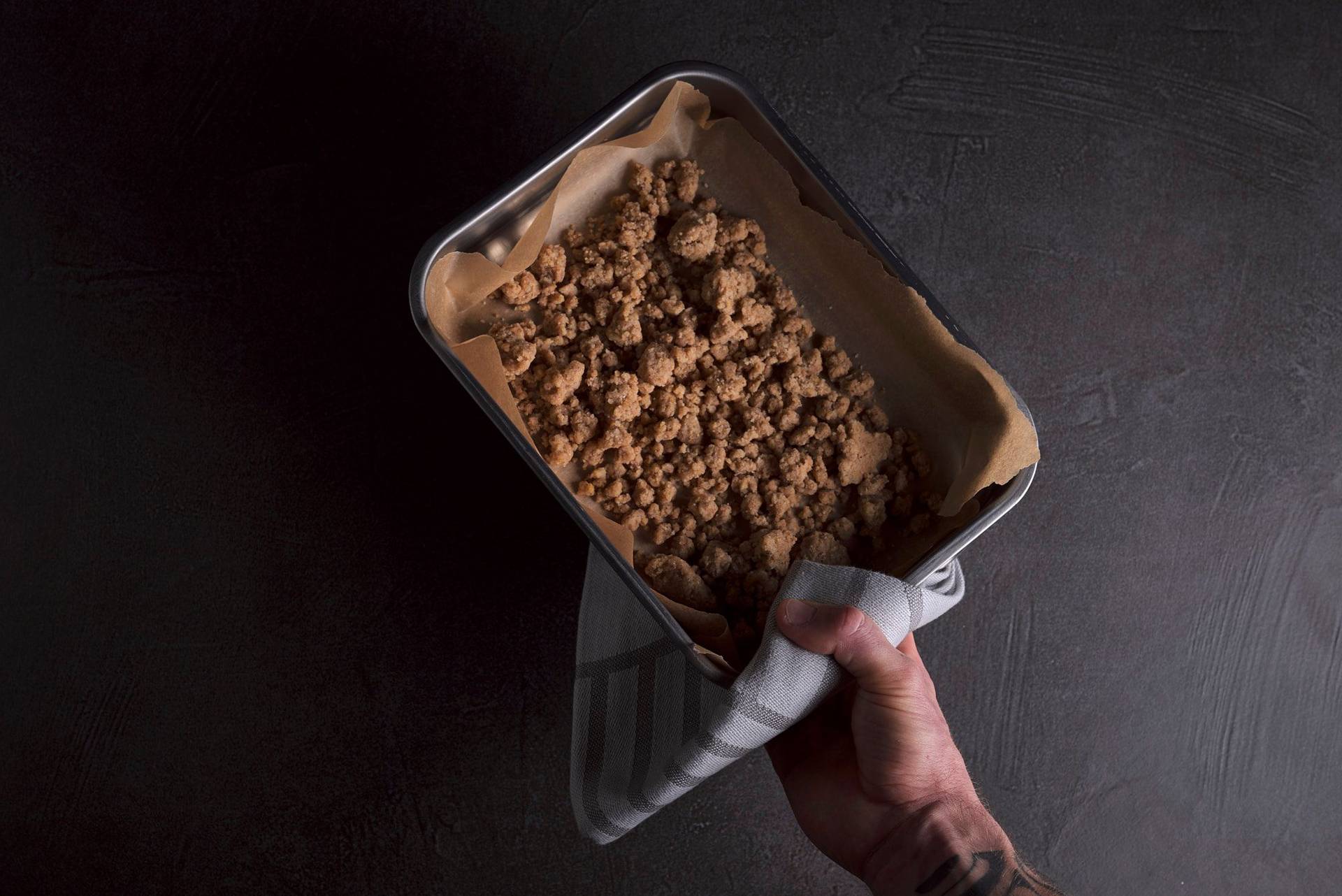 freshly baked spelt crumble in a baking pan with gray sapienstone top