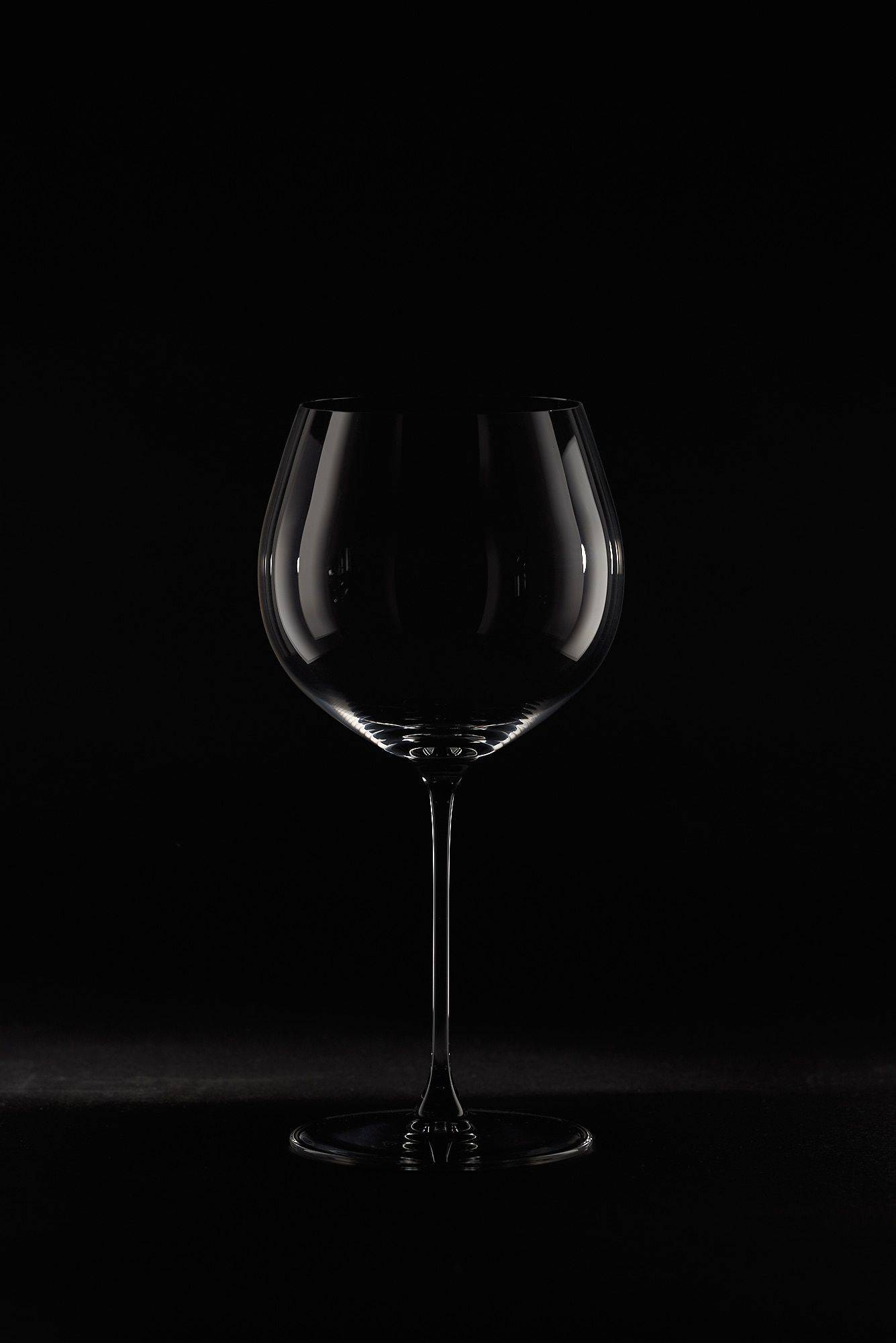 riedel veritas oaked chardonnay wine glass on black background