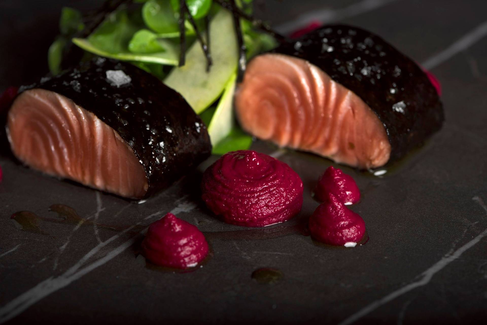 confit salmon with beetroot hummus on a gray sapienstone top