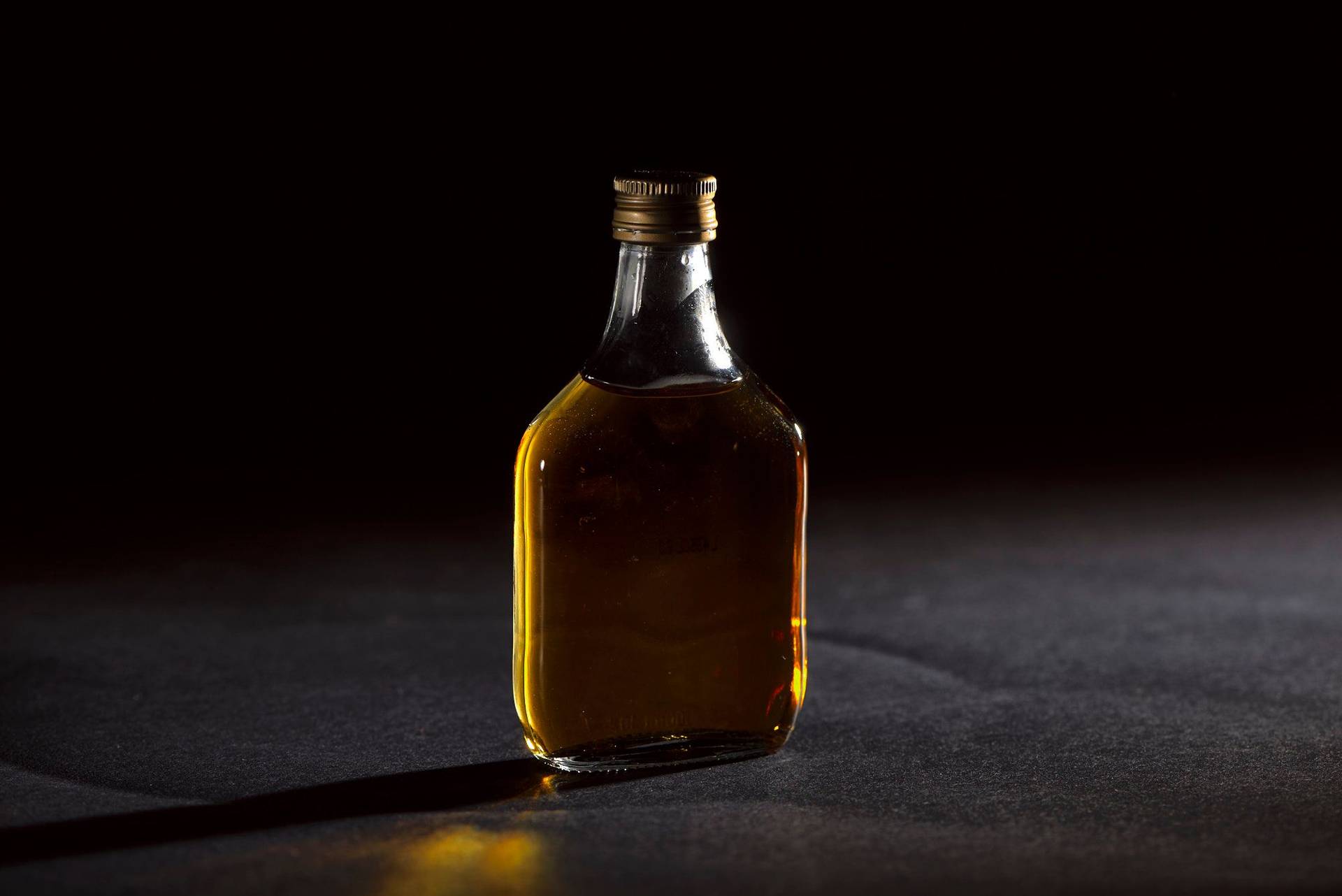 whiskey a small bottle of whiskey on black background