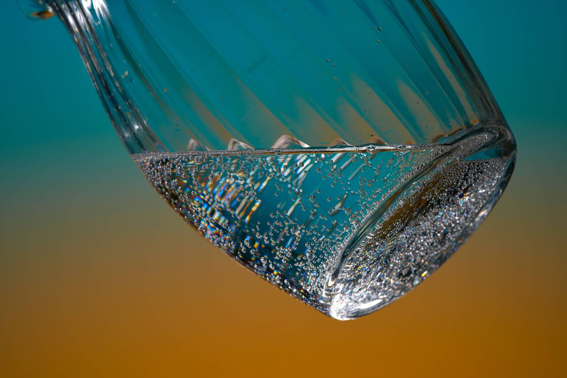 a jug of soda water on blue and orange background