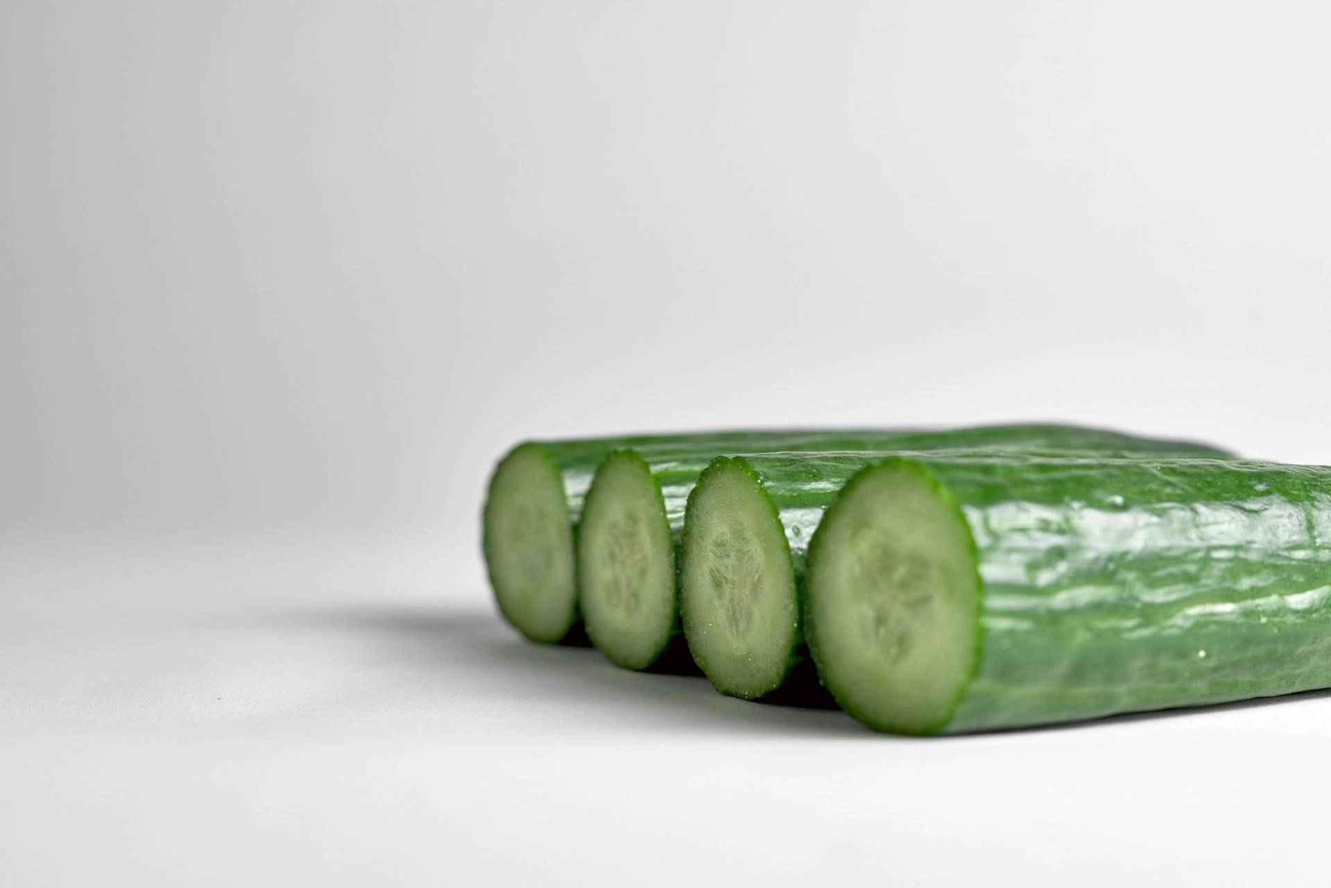 ingredients for a cucumber daiquiri cocktail on white background