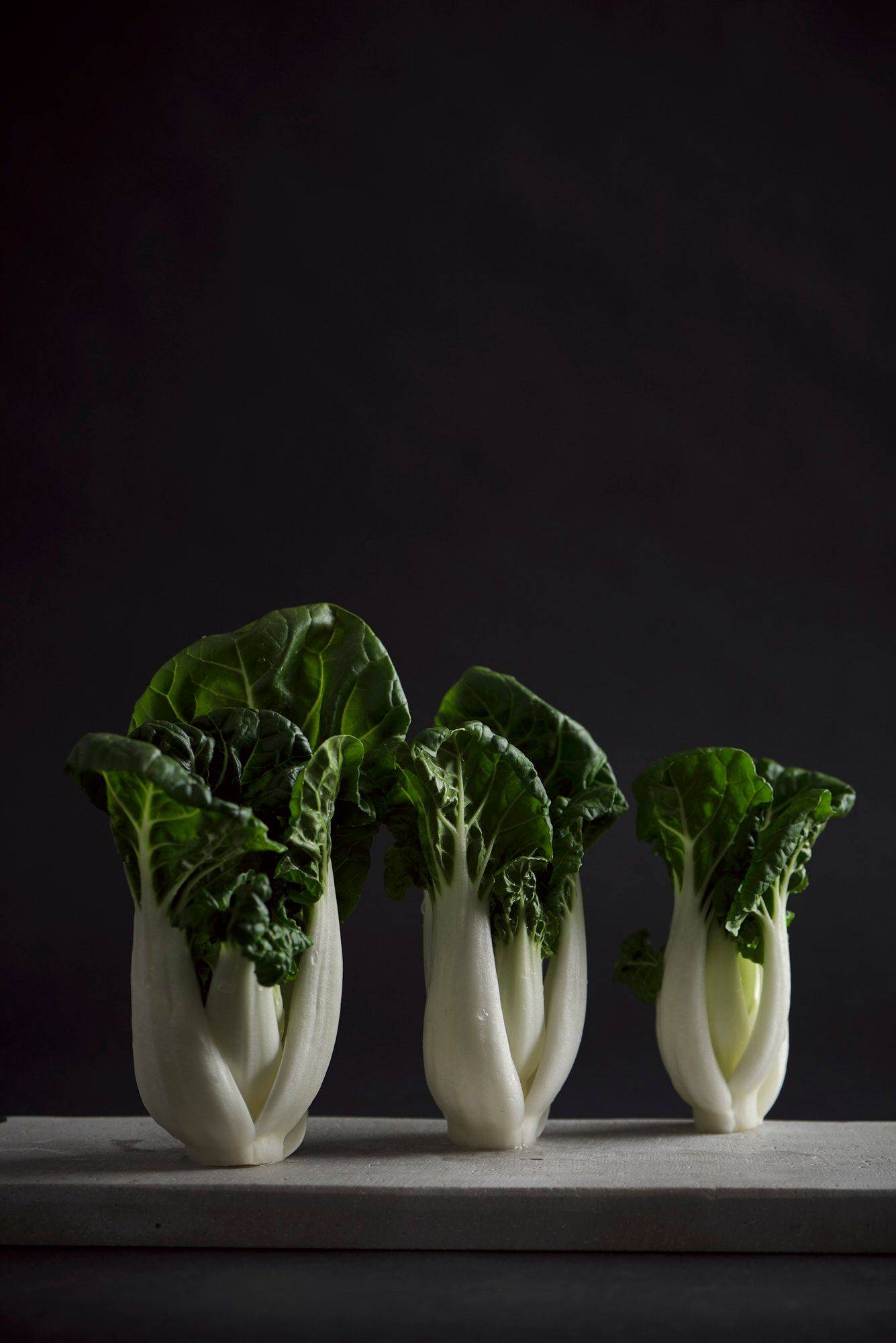 three pak choi on a gray sapienstone top