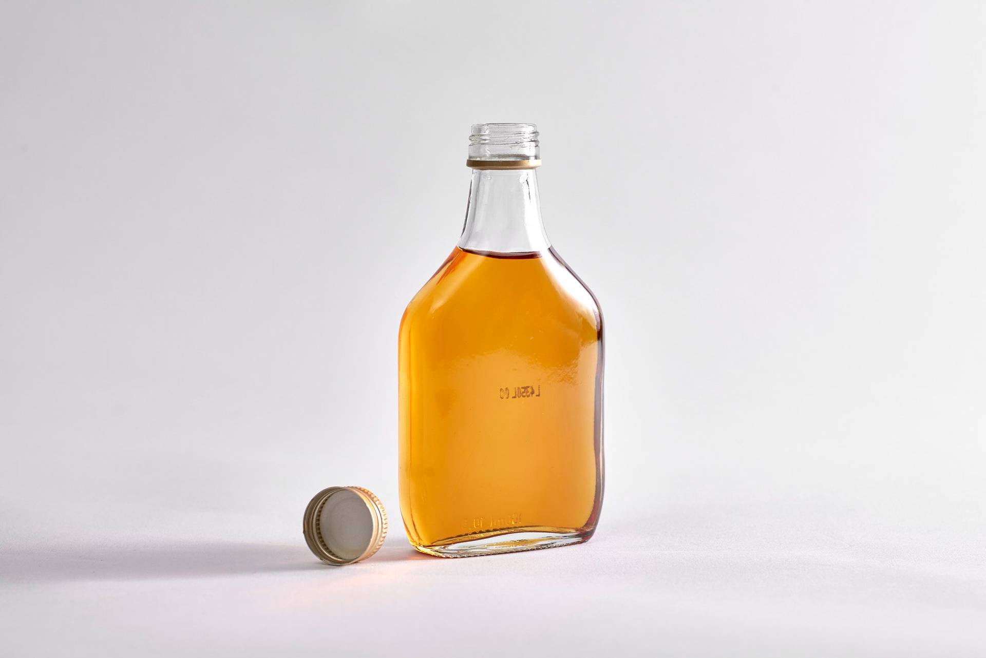 a small bottle of rum on white background