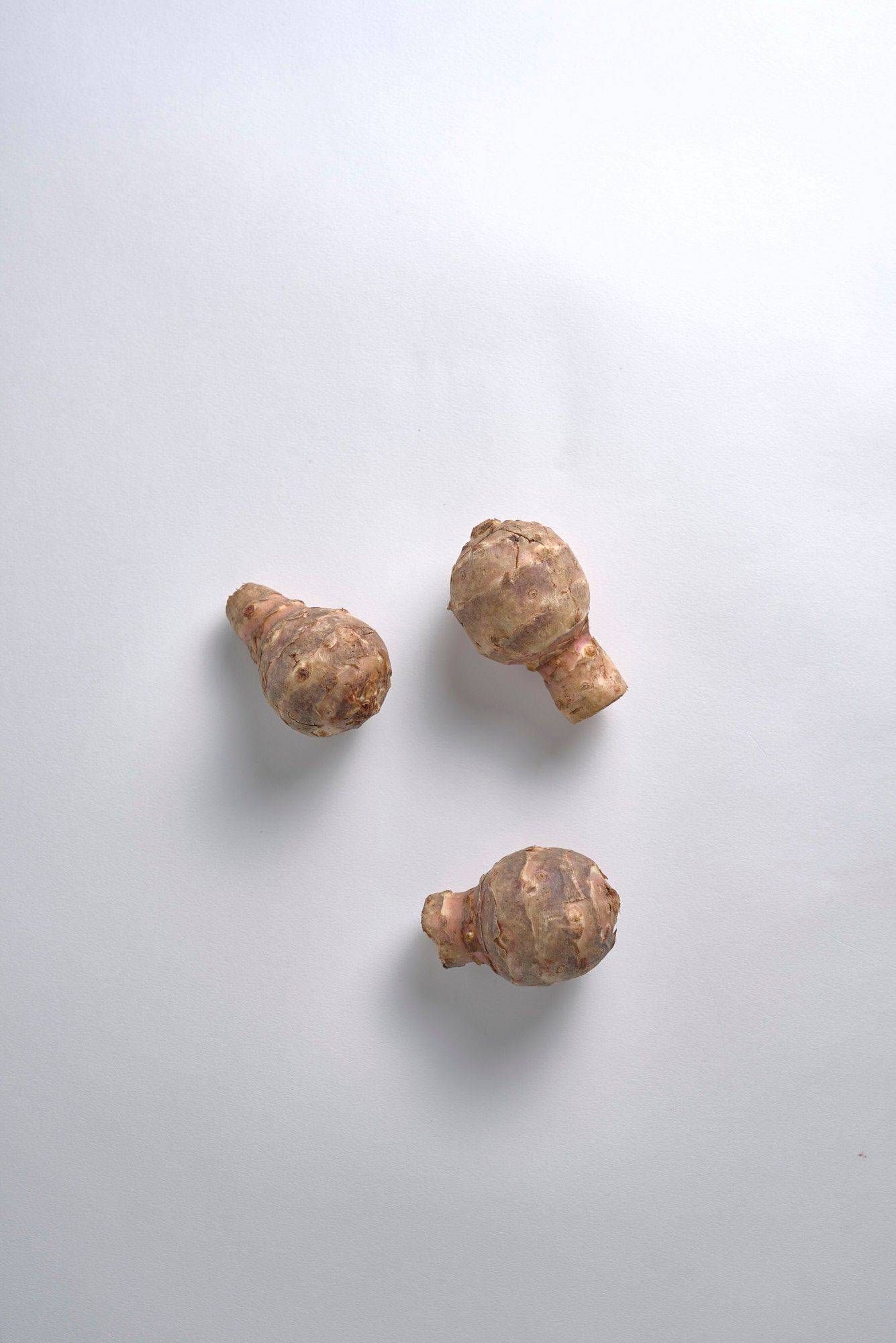 three jerusalem artichokes with white background