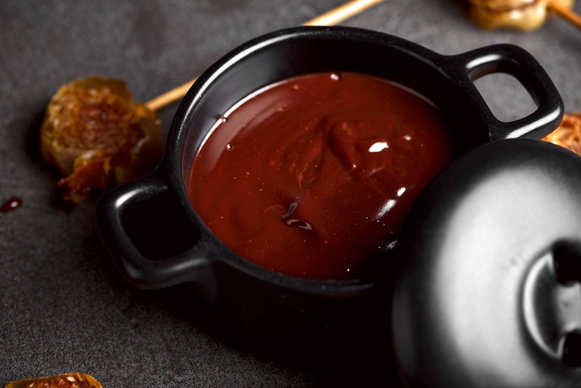 bacon and cinnamon lollipops with dark chocolate on a sapienstone top