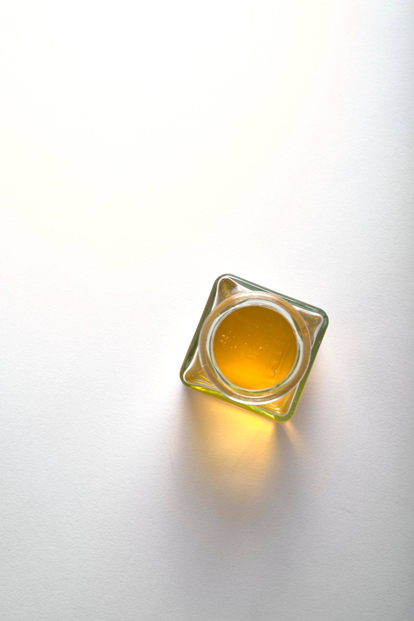 linseed oil in a glass jar with white background