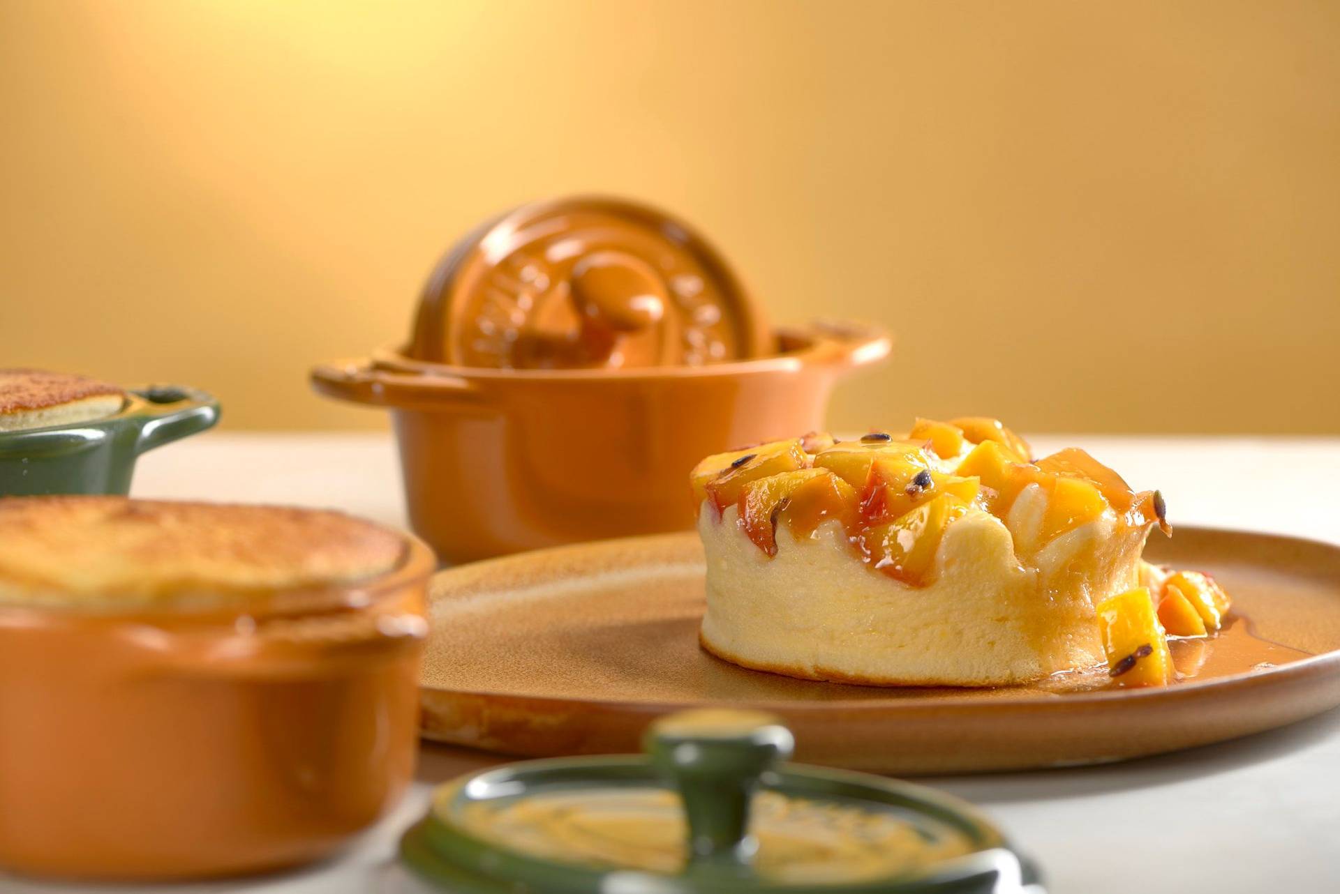 skyr souffle with lavender nectarines in small staub cocottes on white sapienstone top with yellow background