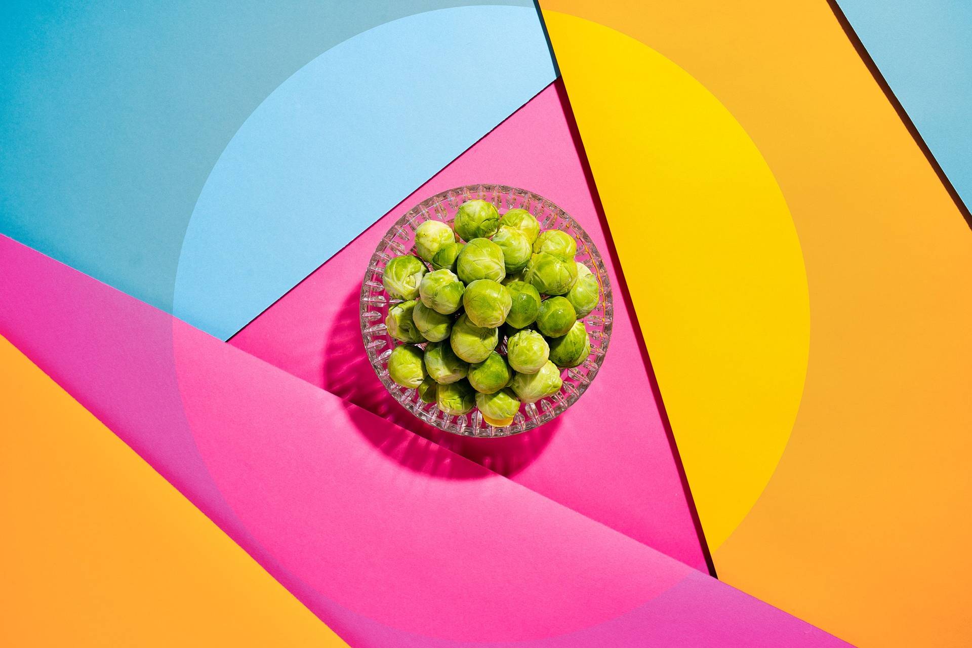 brussels-sprouts brussels sprouts in a glass bowl on colorful underground