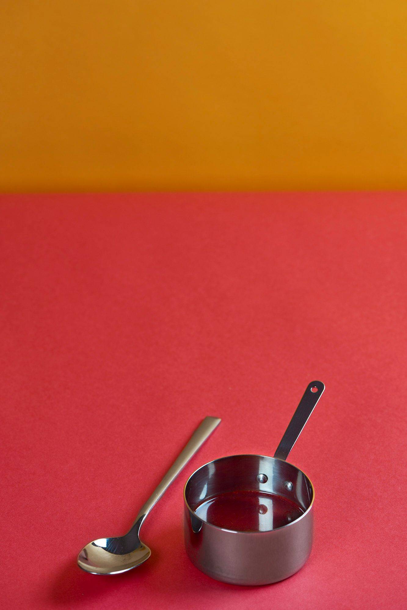 vegan-jus vegan jus in a mini sauce pan with red and yellow background