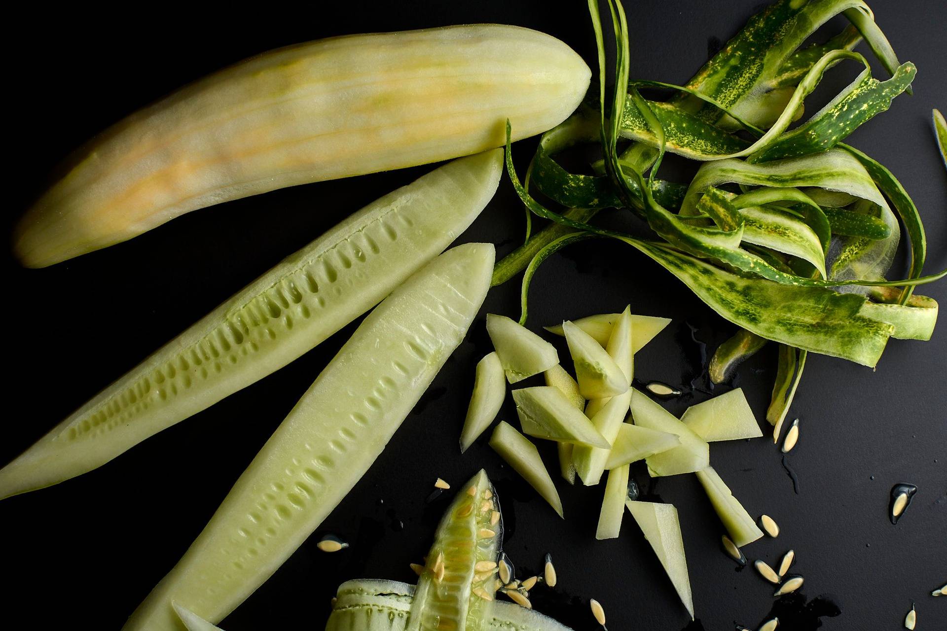 chopped cucumber on black background