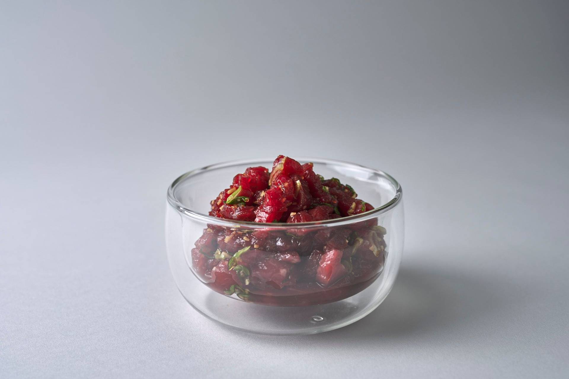 marinated bulgogi beef in a glass bowl with white background