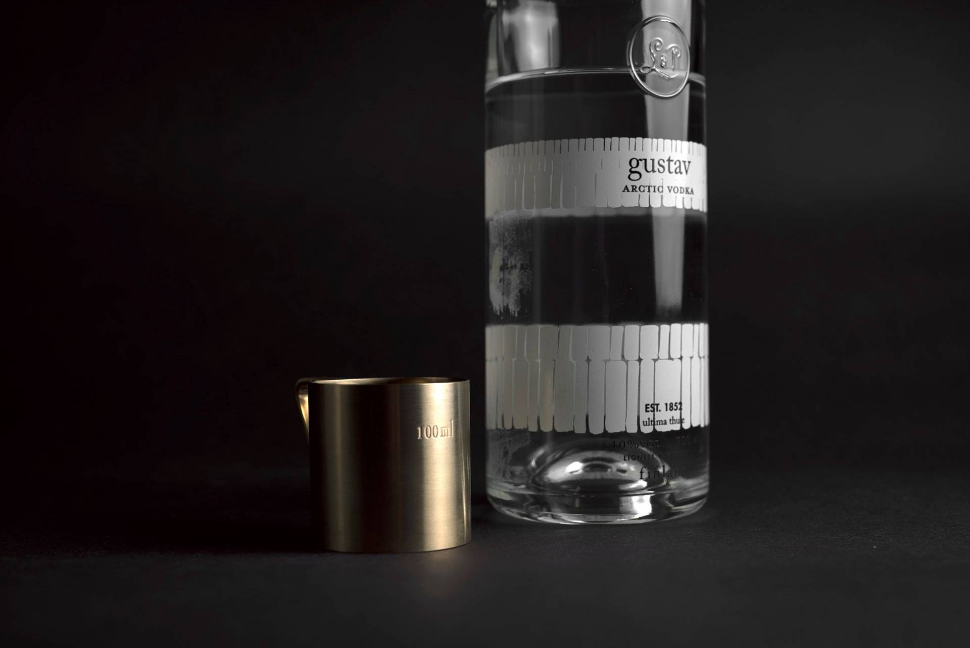 gustav-vodka gustav vodka with brass measuring cup on black background