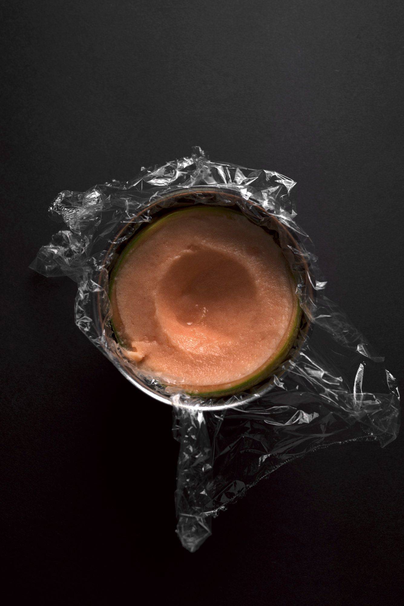making-cantaloupe-melon-sorbet cantaloupe melon sorbet in a bowl with black background