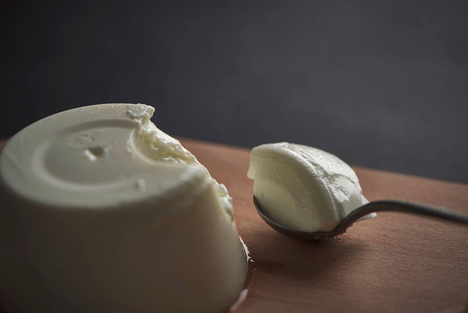 greek yogurt on a wooden board on a gray sapienstone top